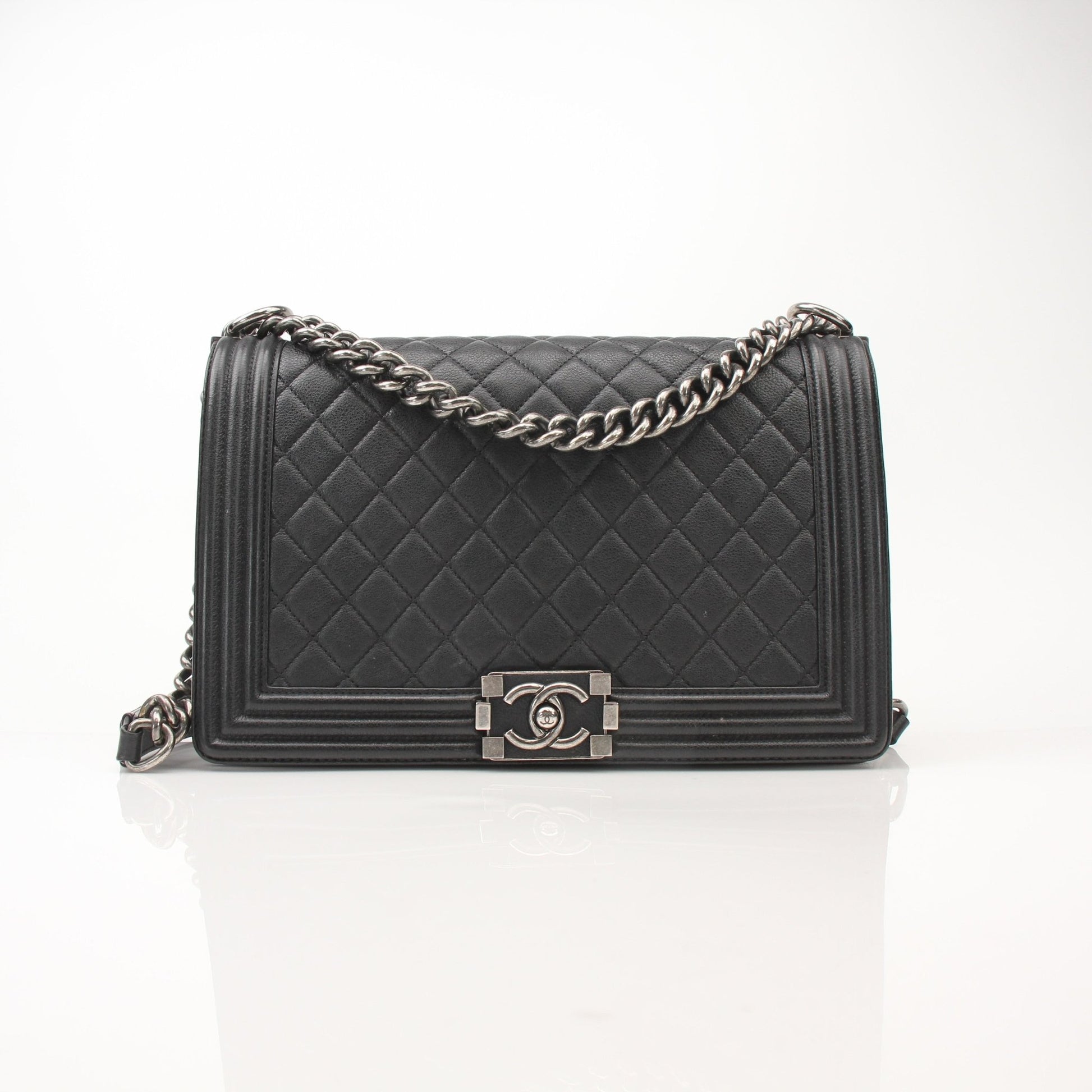 Gold & Beyond Chanel Boy Quilted Flap Bag handbag with gold hardware and signature quilted design, stylishly displayed.