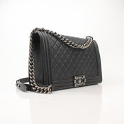 Gold & Beyond Chanel Boy Quilted Flap Bag handbag with gold chain strap and signature quilted leather design.