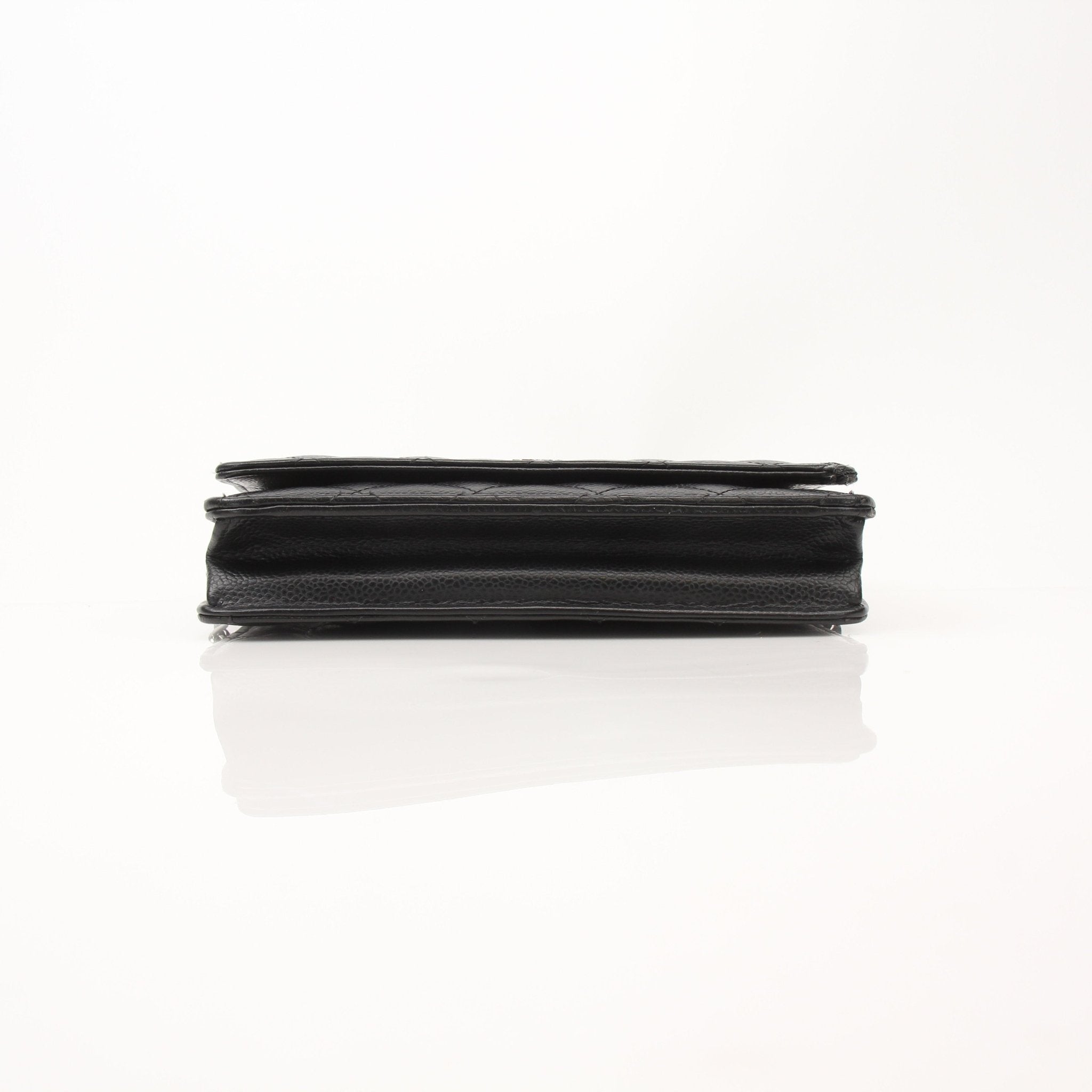 Black Chanel Wallet on Chain with gold accents, featuring a sleek leather design and chain strap for stylish carrying.