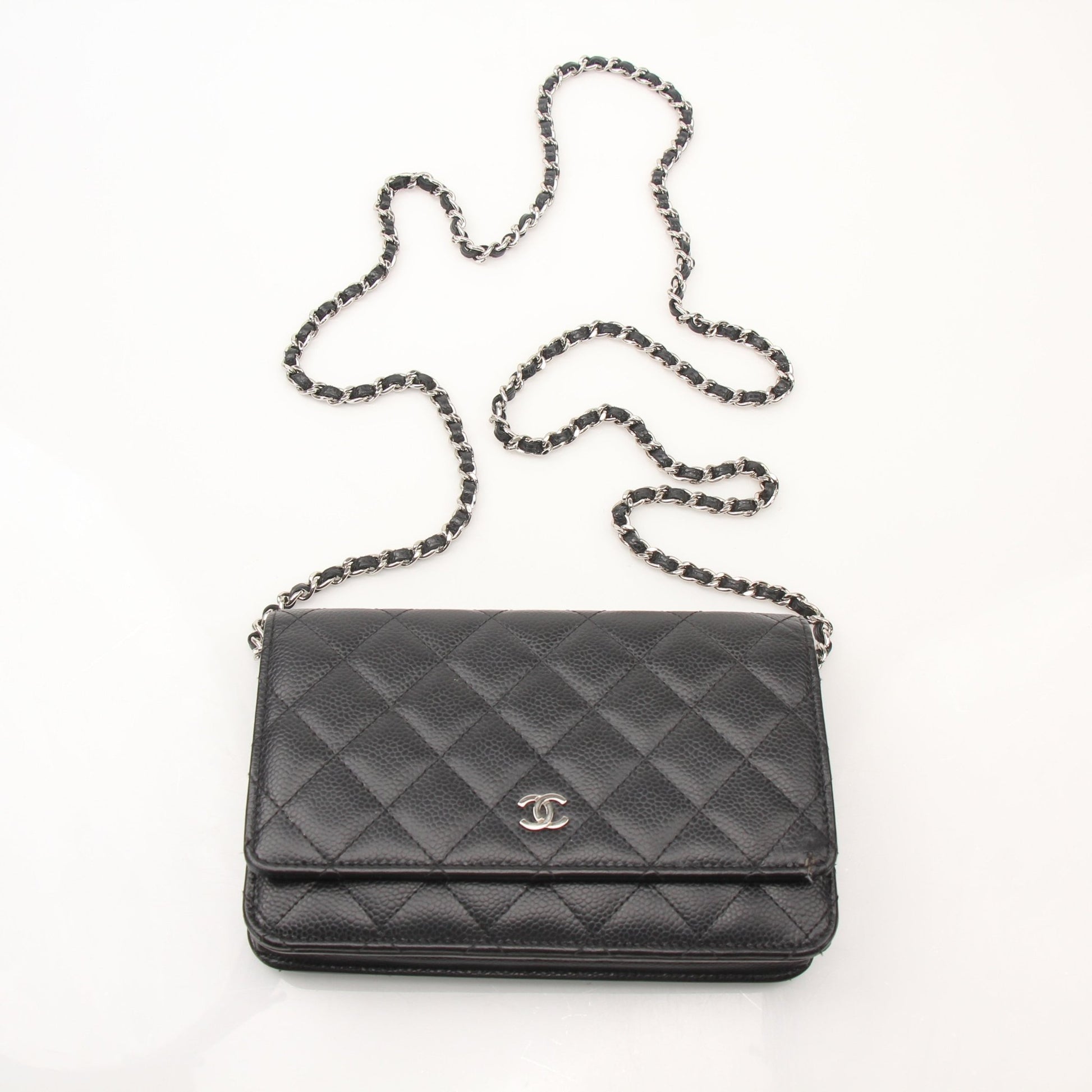 Gold & Beyond black Chanel wallet on chain with gold hardware, featuring a sleek design and compact wallet style.