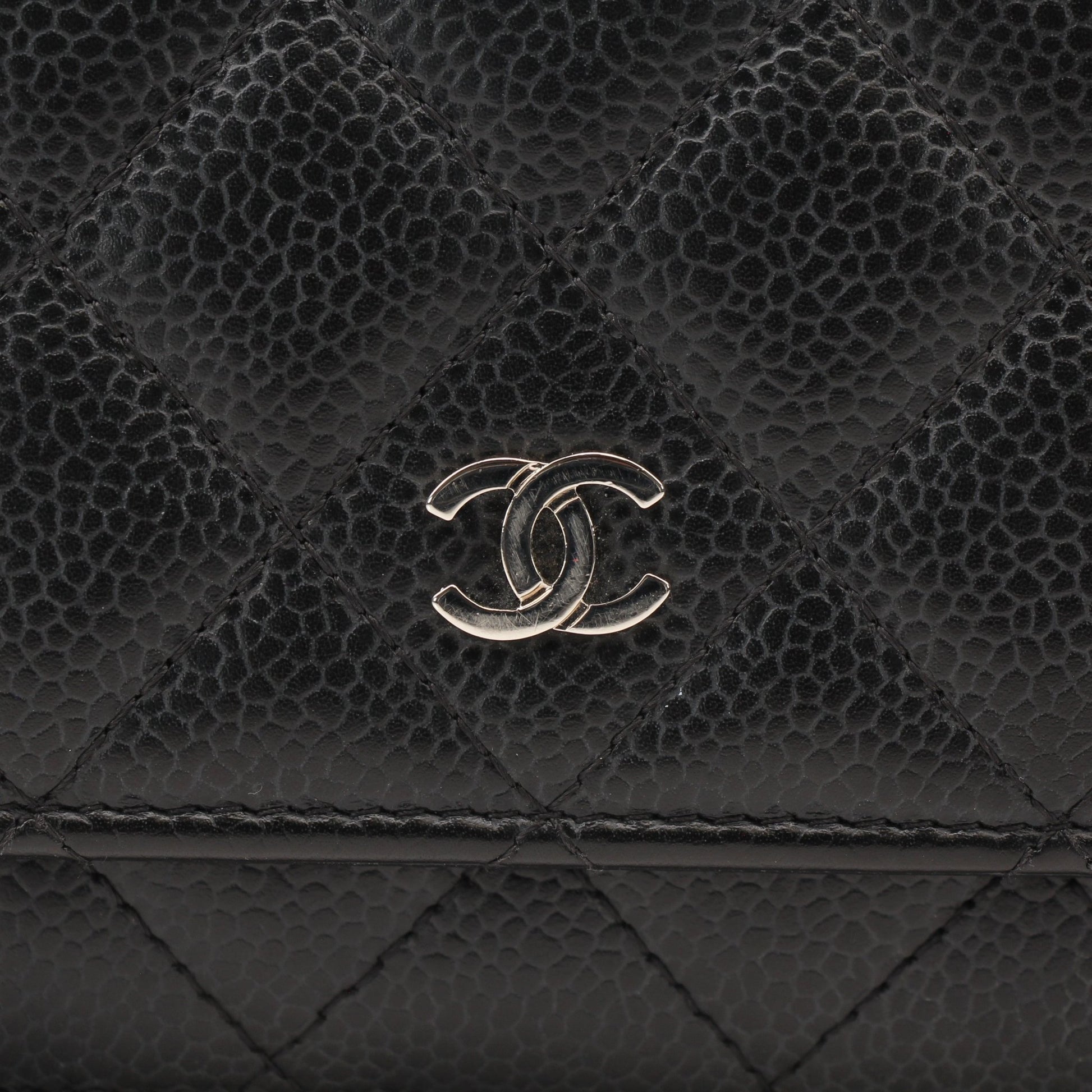 Chanel black wallet on chain with gold accents, compact leather wallet featuring chain strap and signature quilted design.