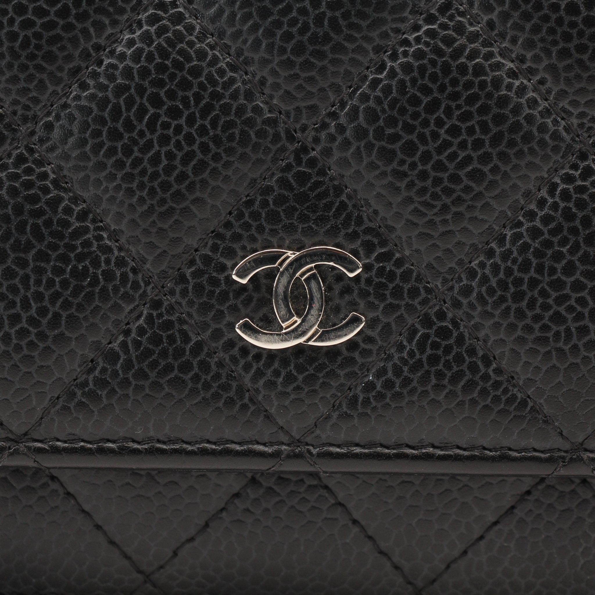 Chanel black wallet on chain with gold accents, compact leather wallet featuring chain strap and signature quilted design.