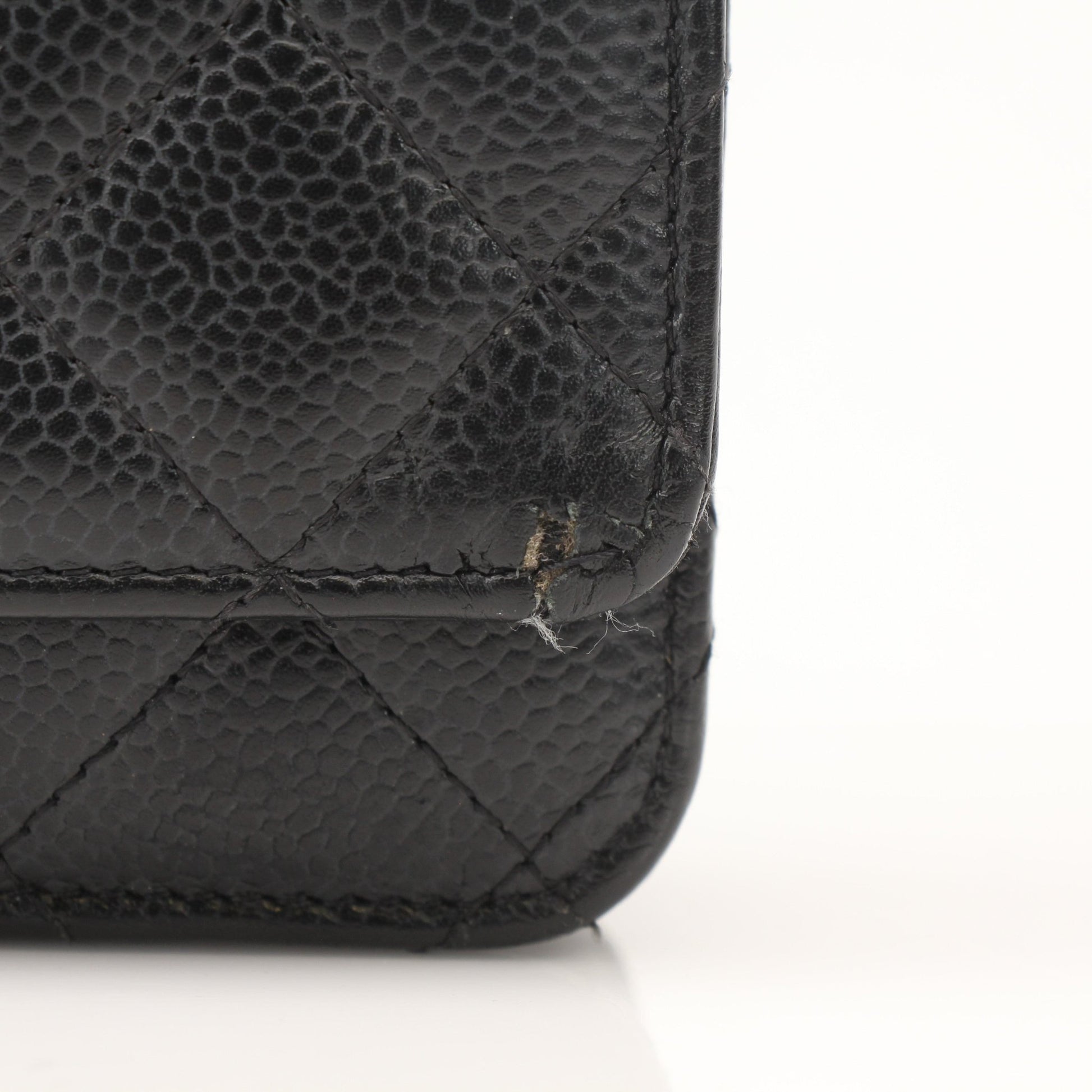 Gold & Beyond black Chanel wallet on chain with gold hardware and quilted leather exterior, showcasing a stylish and compact design.