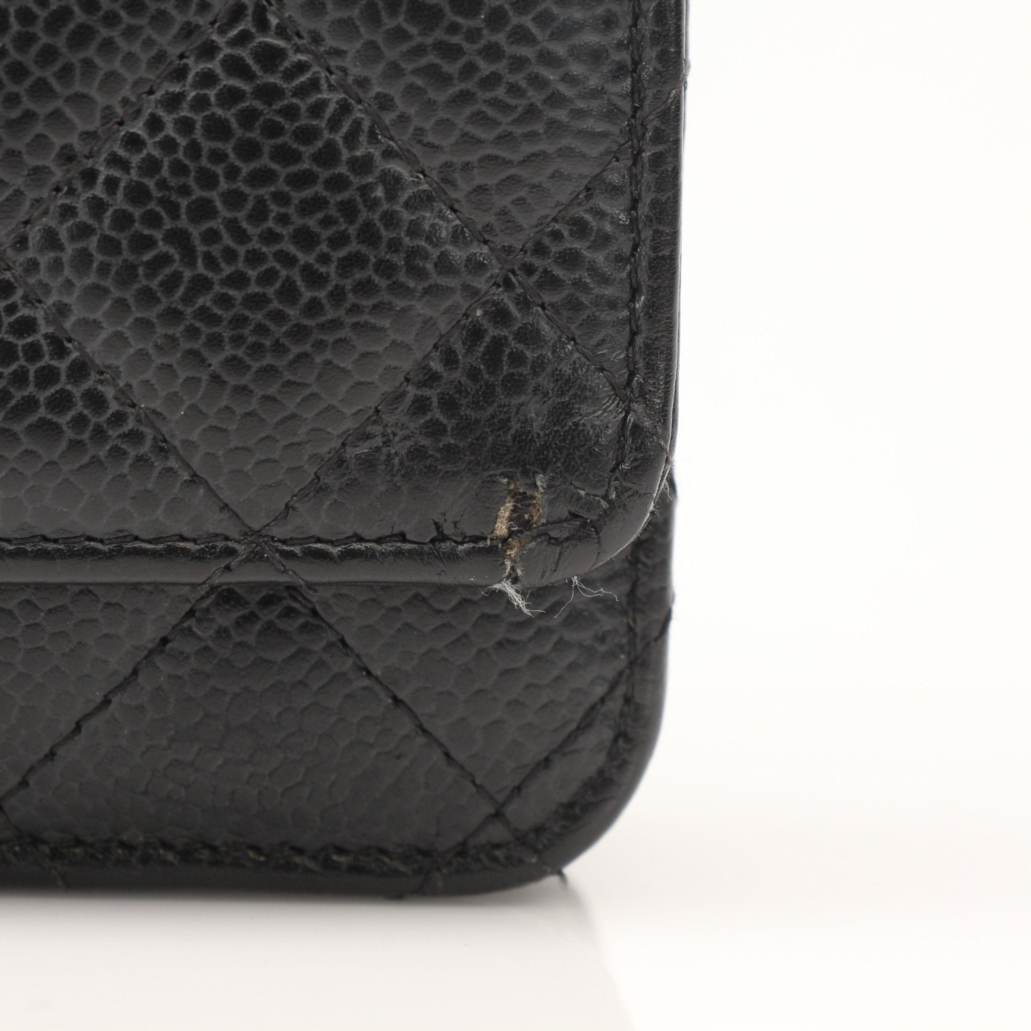 Gold & Beyond black Chanel wallet on chain with gold hardware and quilted leather exterior, showcasing a stylish and compact design.