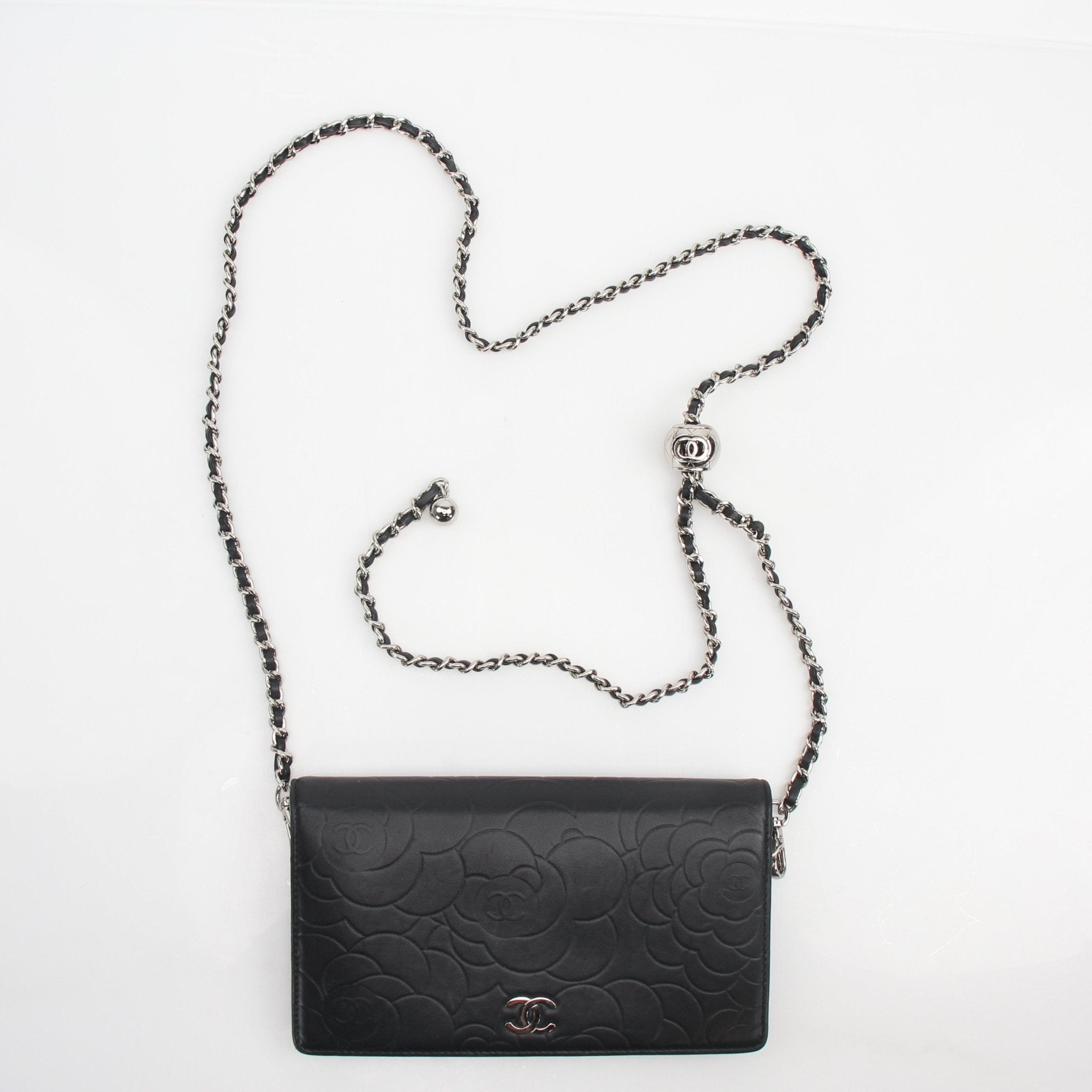 Gold & Beyond Chanel Camellia embossed wallet on chain handbag with silver hardware and floral embossed leather detail.