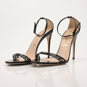 Gold & Beyond Gucci Isle ankle strap heels with pointed toes and sleek design, shown on a model.
