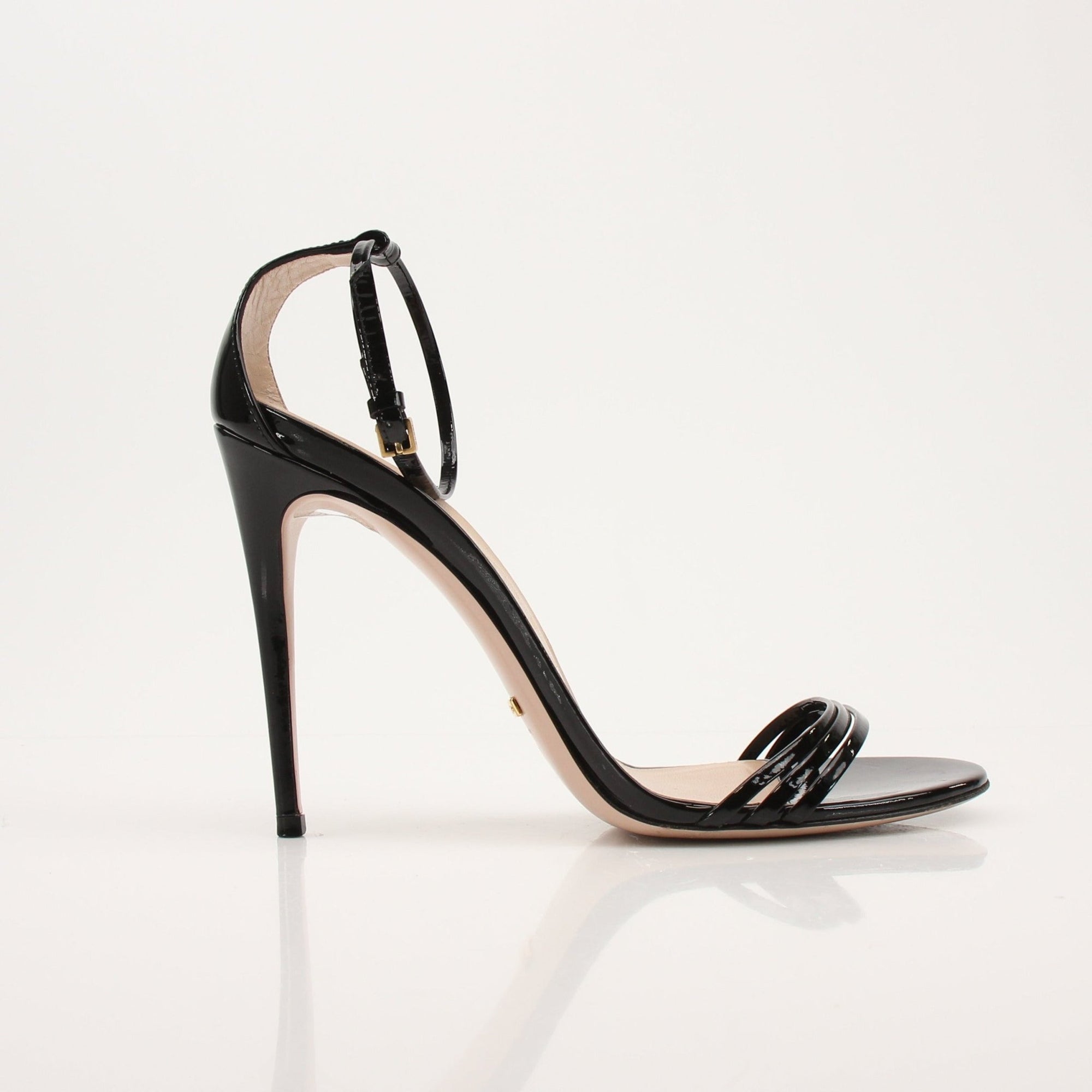 Gold & Beyond Gucci Isle ankle strap heels with elegant design and stiletto style, shown on a neutral background.
