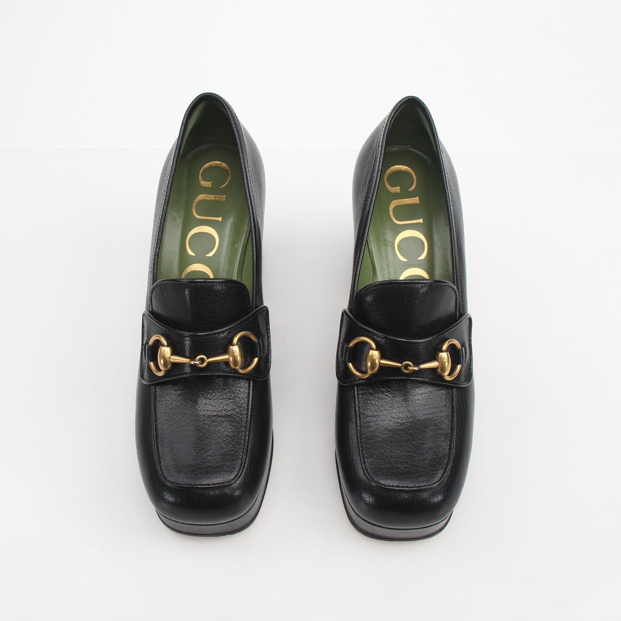 Gucci women's Houdan Horsebit platform loafer pumps in black leather with gold hardware and chunky soles.