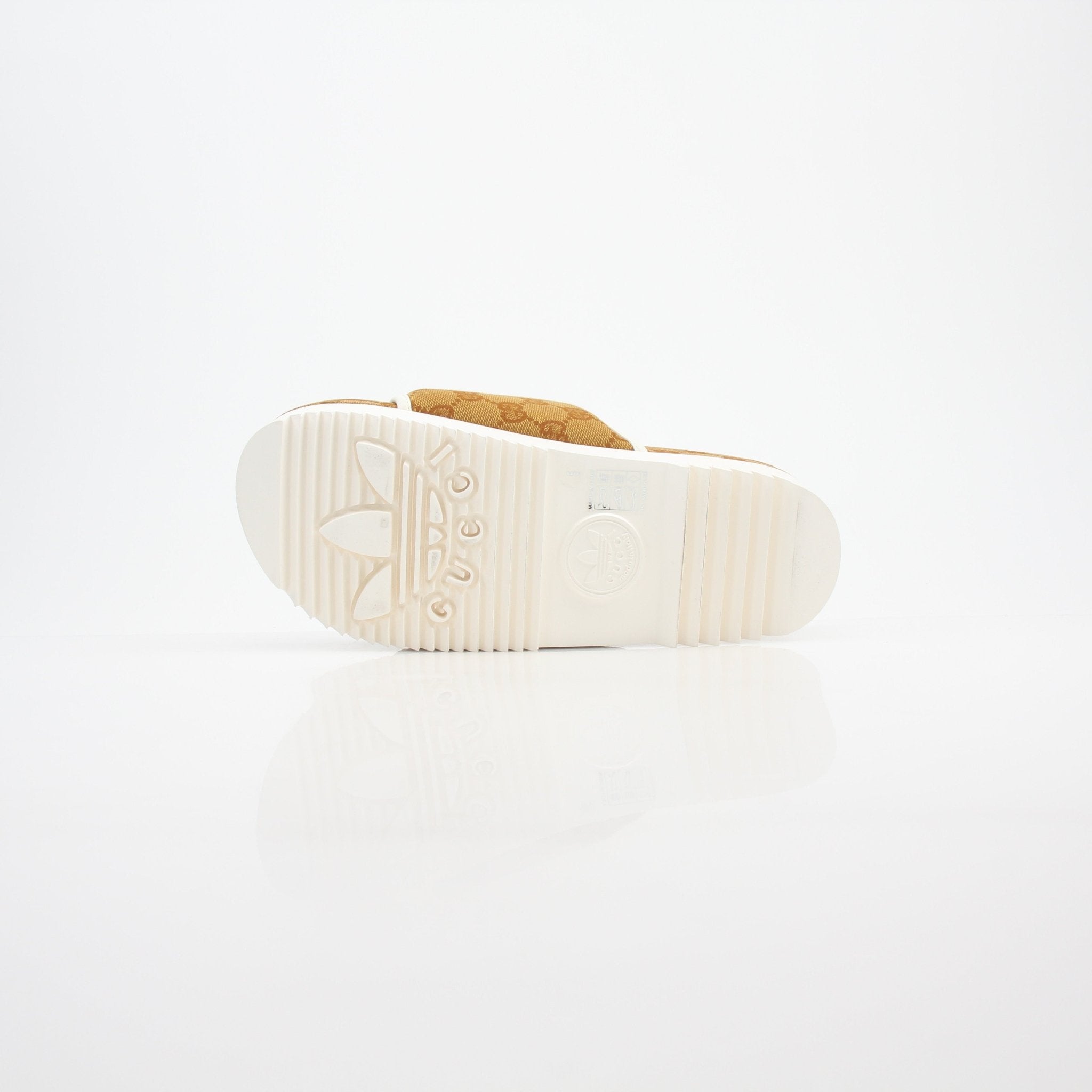 Gucci x Adidas GG Canvas Trefoil Platform Slide Sandals with logo straps and chunky soles, displayed on a plain background.