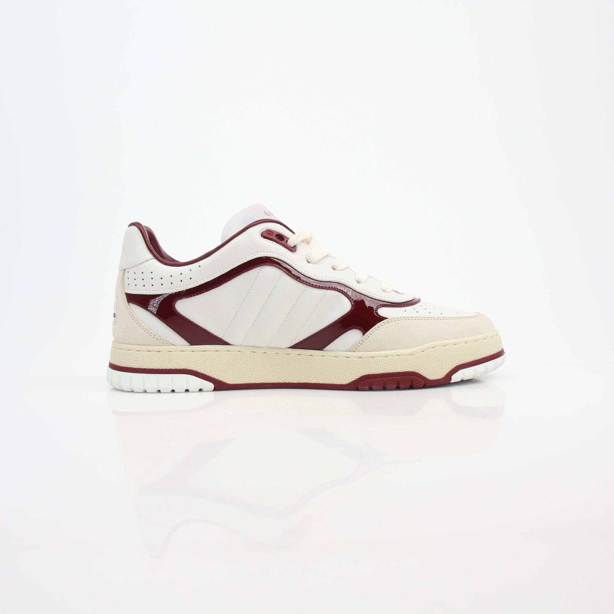 Gucci men's Re-Web low top leather sneakers with signature striped detail, black leather, and white rubber soles.