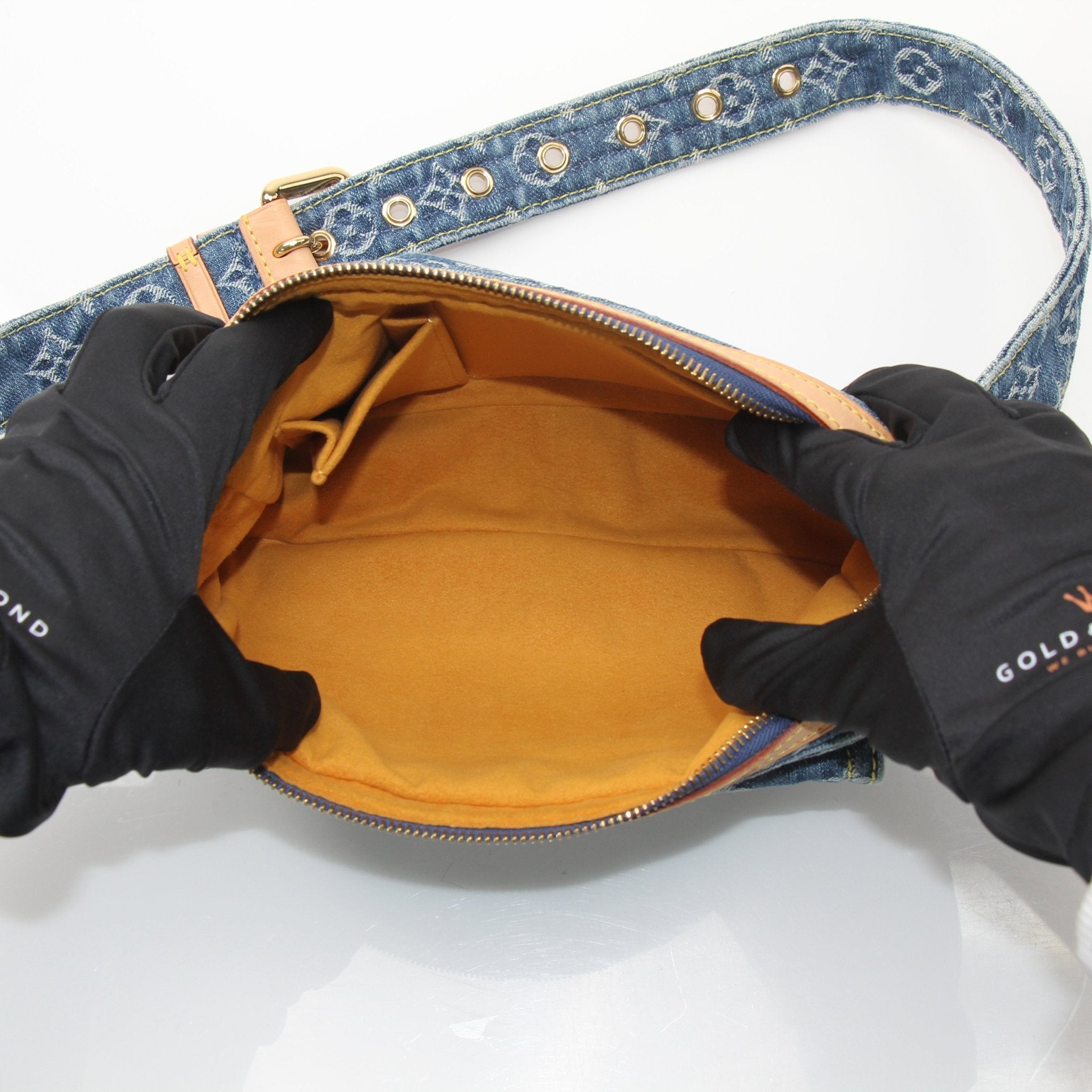Louis Vuitton denim bum bag handbag with gold accents, featuring a compact design and adjustable strap for versatile wear.