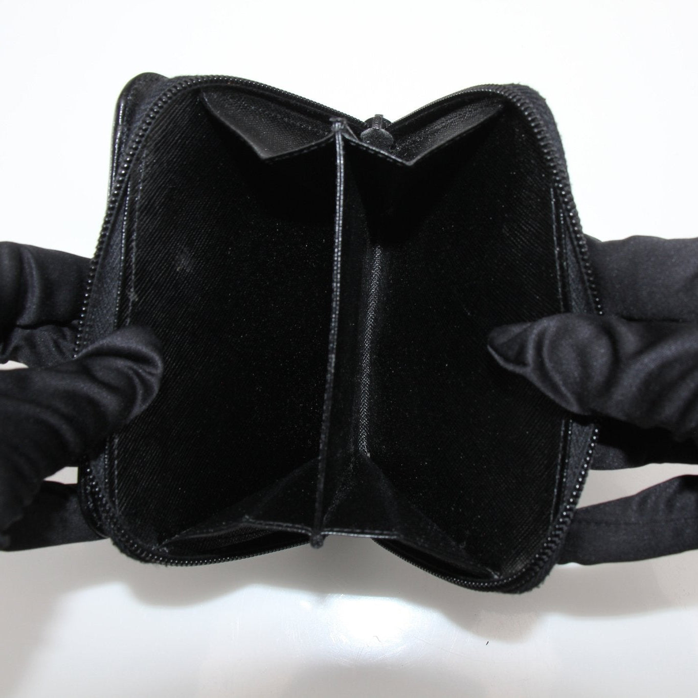 Gold &amp; Beyond Prada zip wallet with sleek design and multiple card slots, shown with its closed zipper and smooth leather finish.