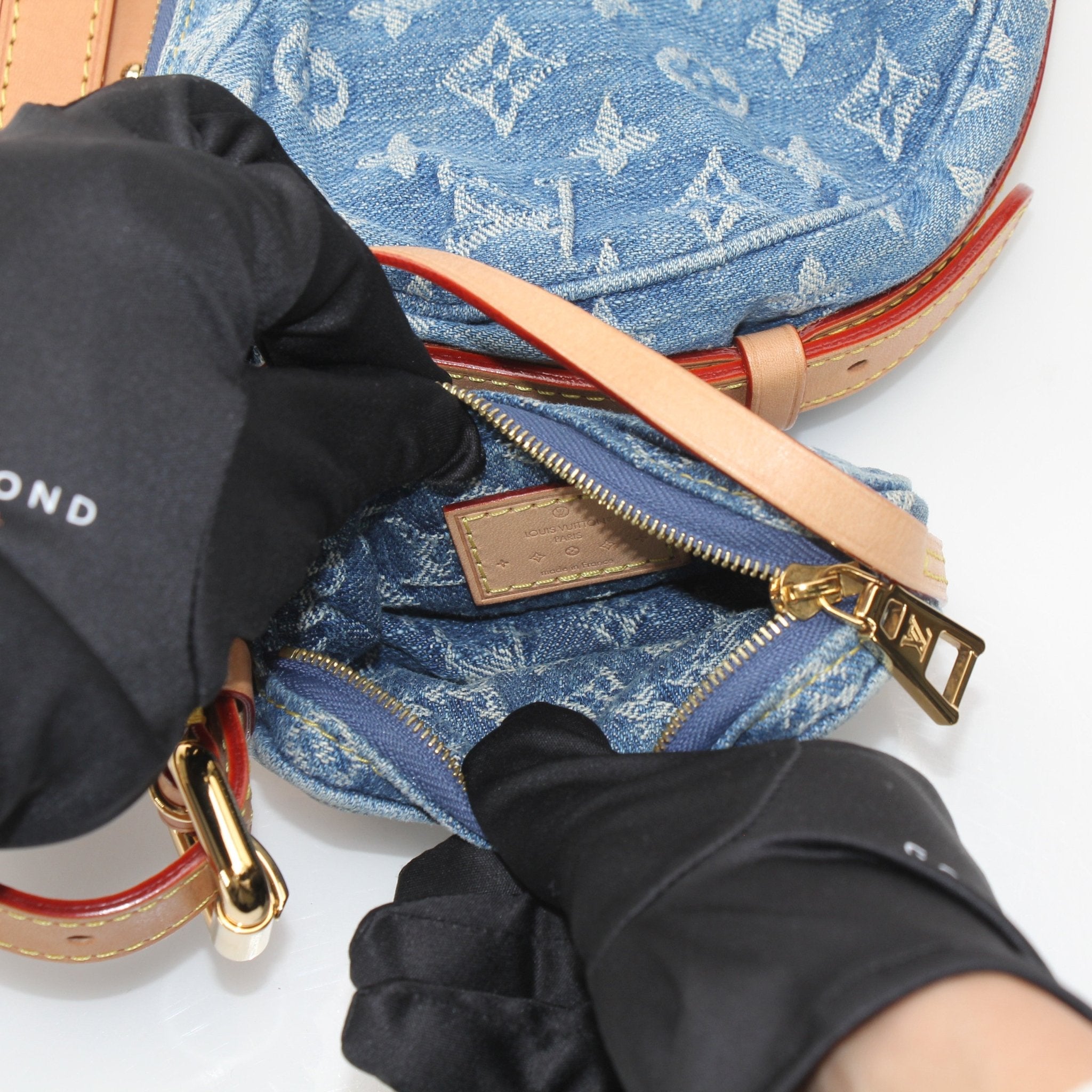Louis Vuitton denim croissant handbag by Gold & Beyond, stylish denim handbag with gold accents and compact design.