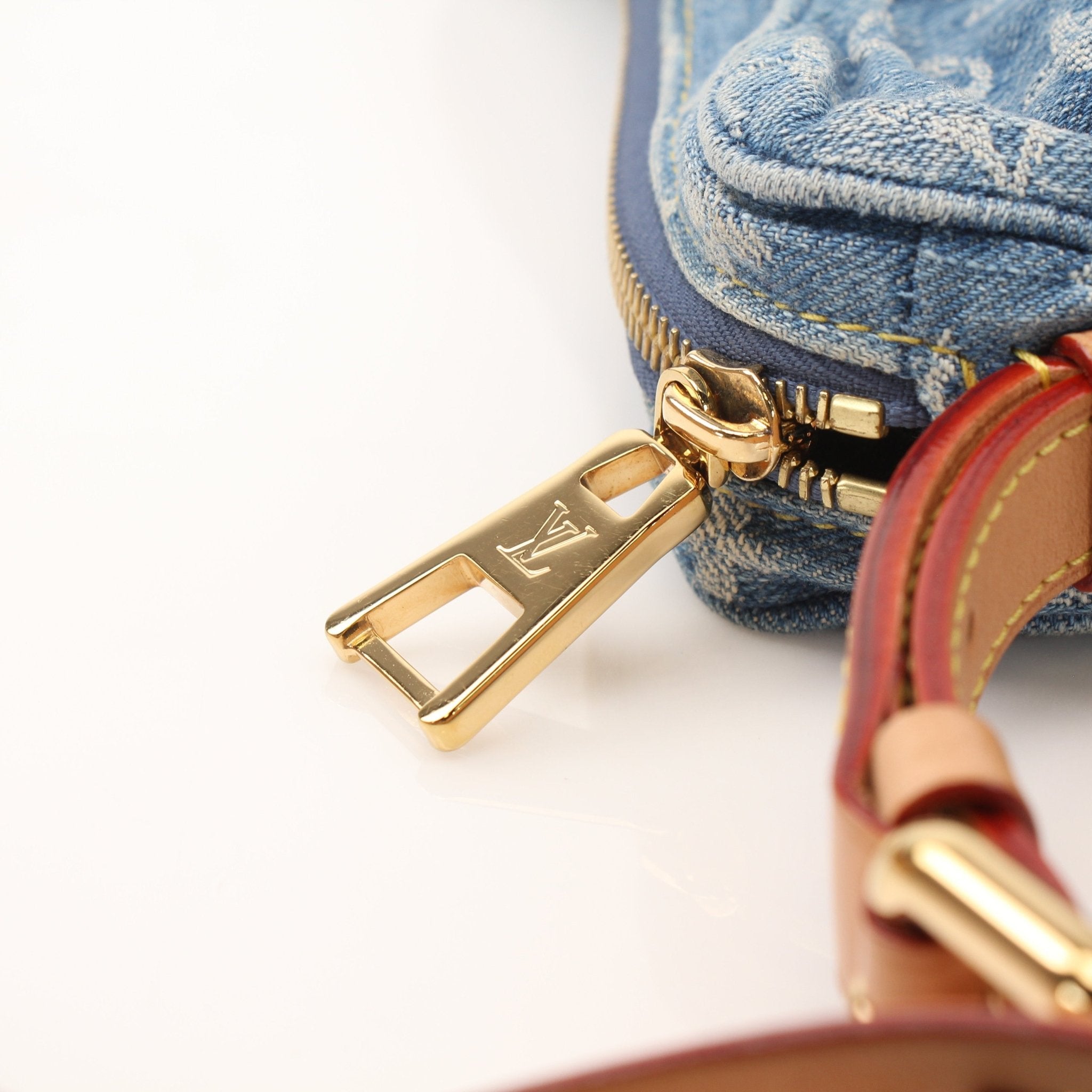 Louis Vuitton Denim Croissant handbag by Gold & Beyond, featuring a stylish denim design and compact shape.