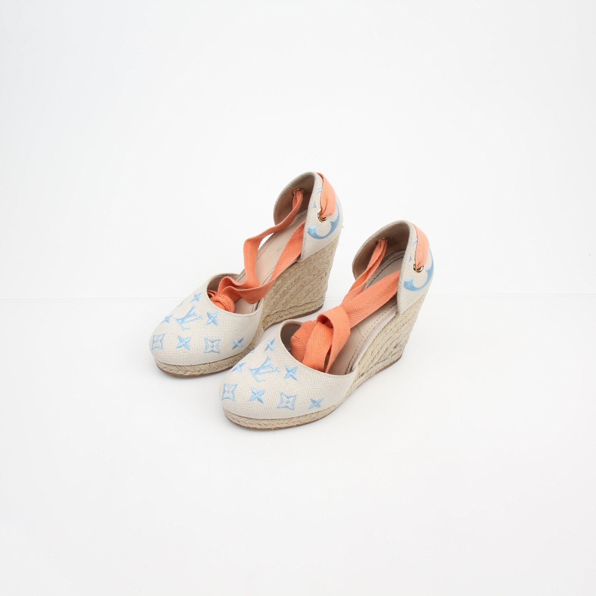 Louis Vuitton women's monogram starboard wedge espadrille heels with gold accents and woven jute sole, casual yet stylish footwear.
