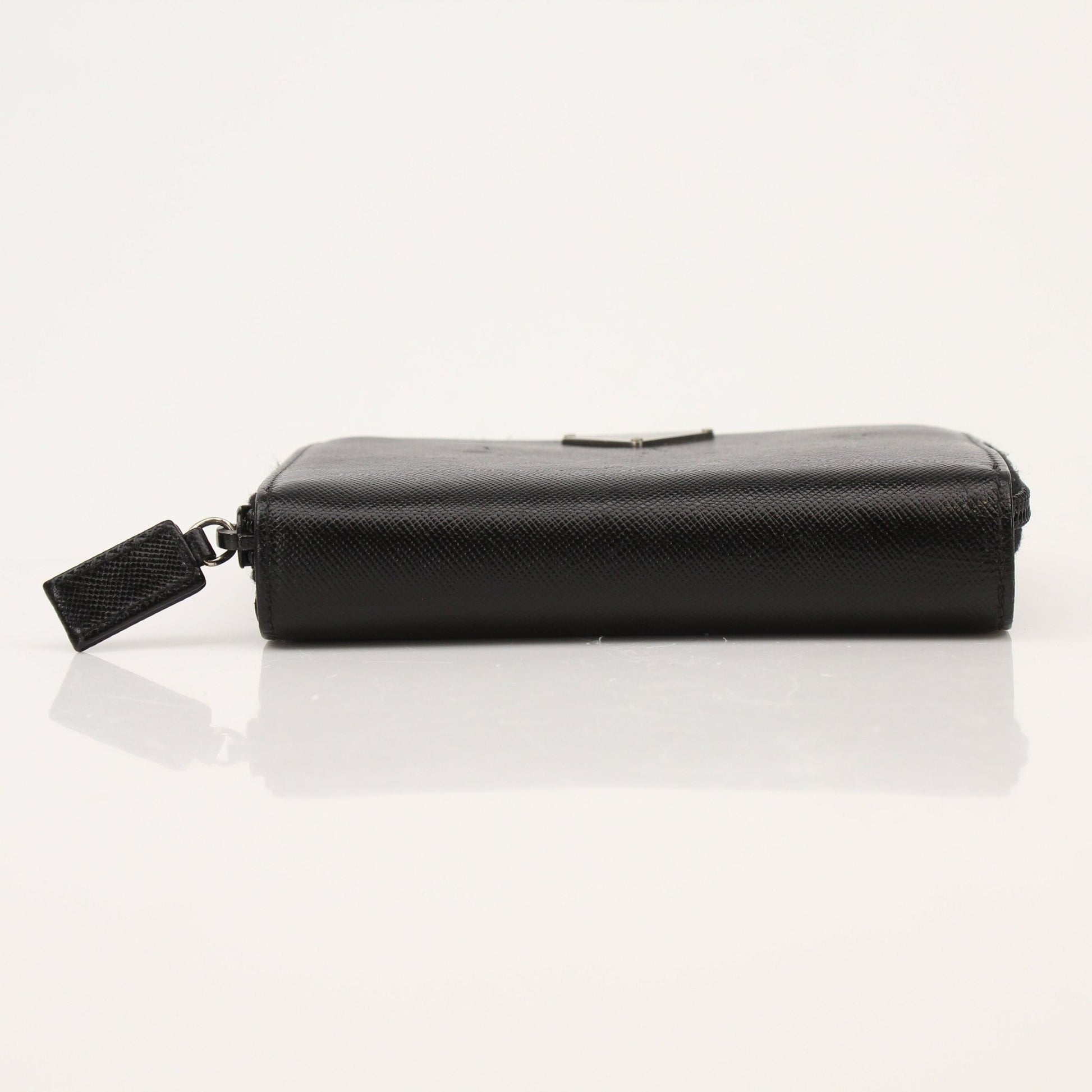 Gold & Beyond Prada zip wallet with sleek design and multiple card slots, shown in black leather.