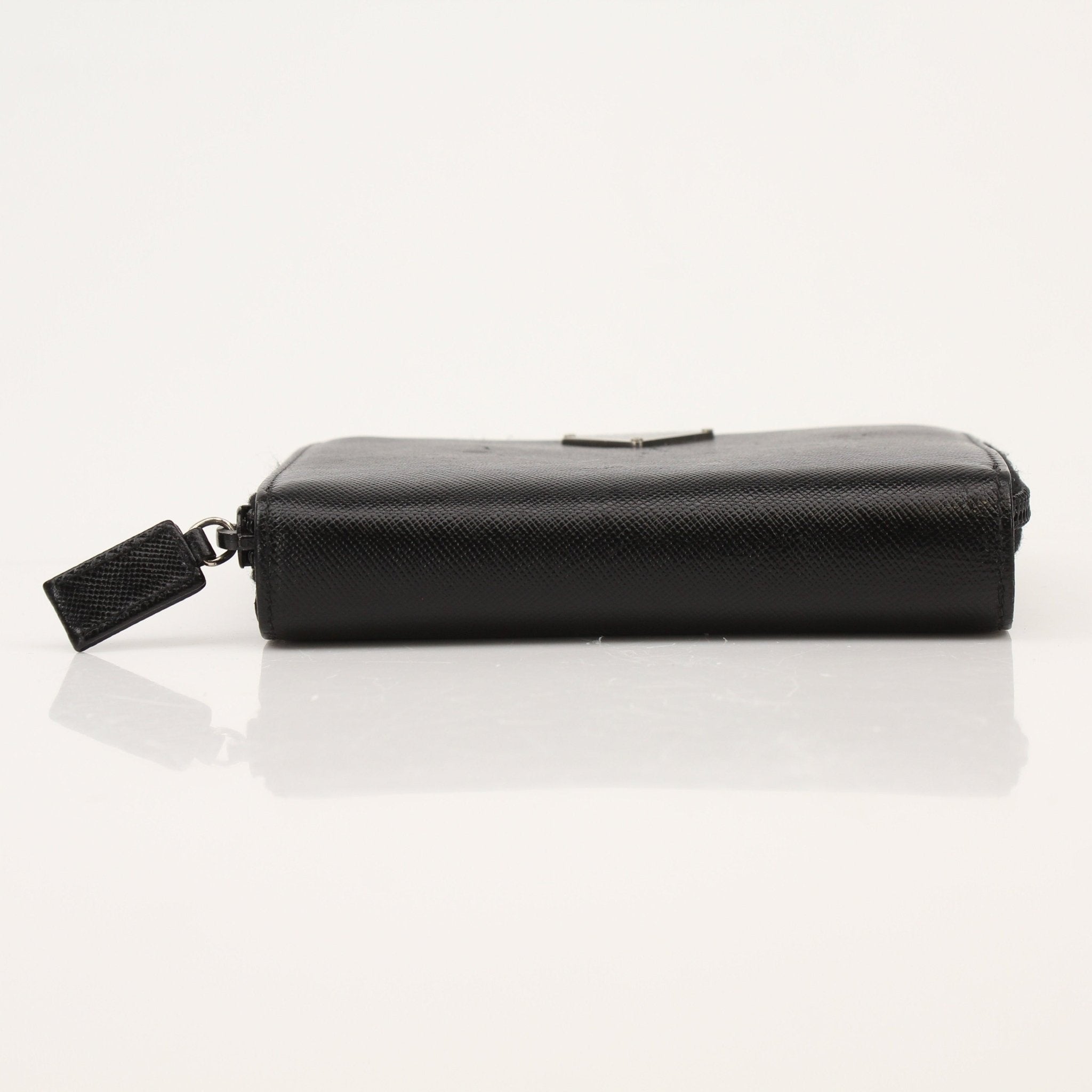 Gold & Beyond Prada zip wallet with sleek design and multiple card slots, shown in black leather.