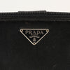 Gold & Beyond Prada zip wallet with sleek design and multiple card slots, shown in black leather on a plain background.