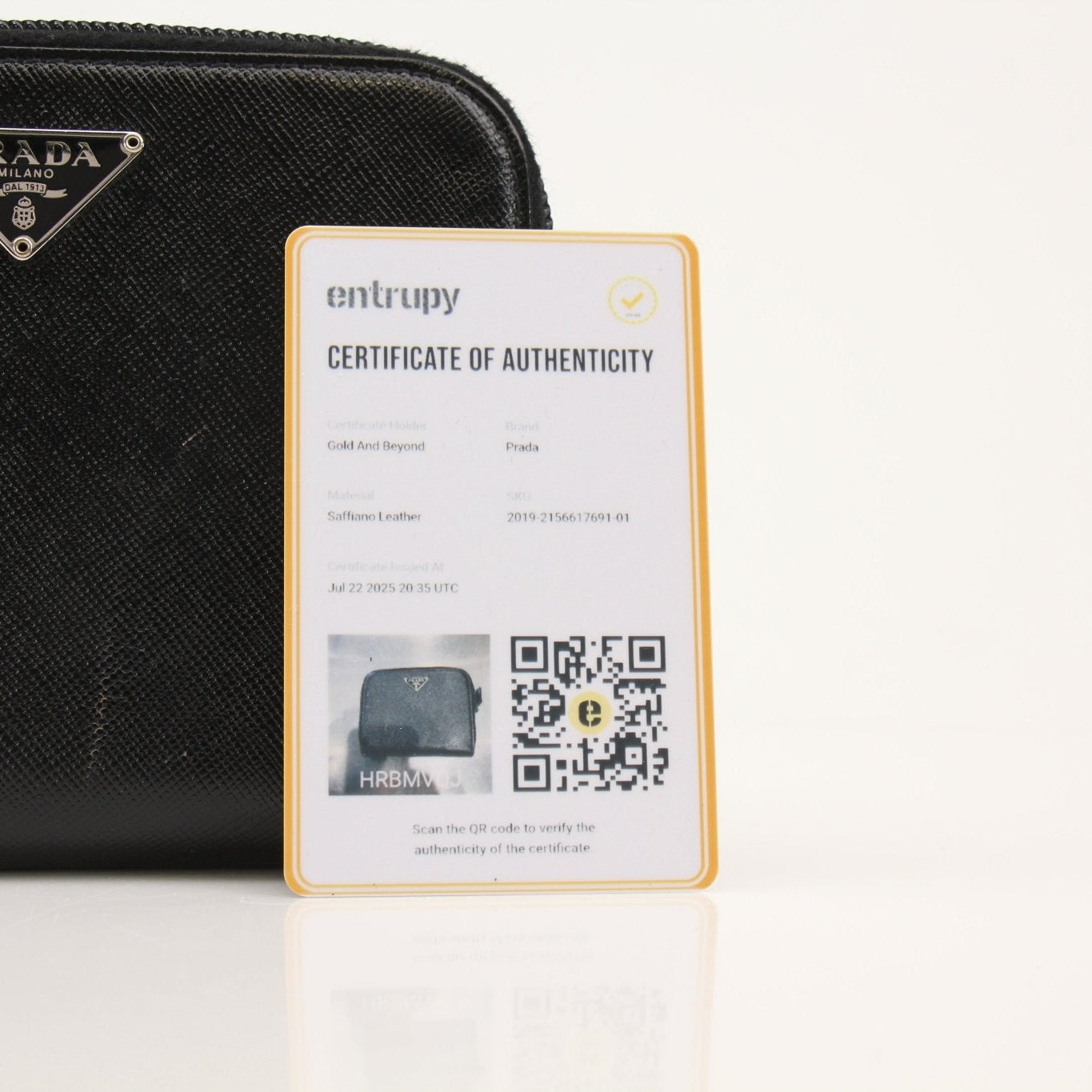Prada zip wallet in black leather with gold-tone zipper and logo detail, compact and stylish for everyday use.