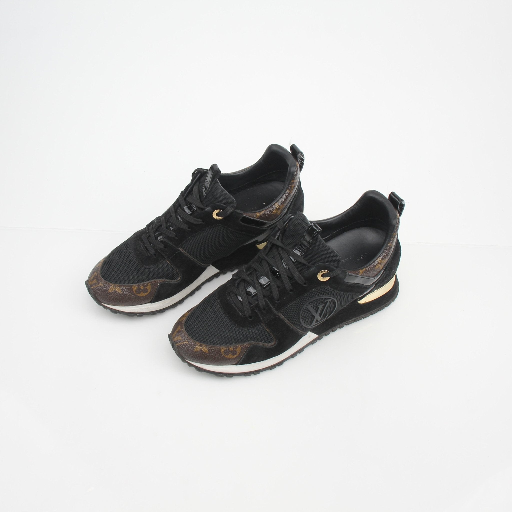 Louis Vuitton Women’s Run Away Monogram sneakers with gold accents, featuring monogram pattern and sporty shoe design from Gold & Beyond.