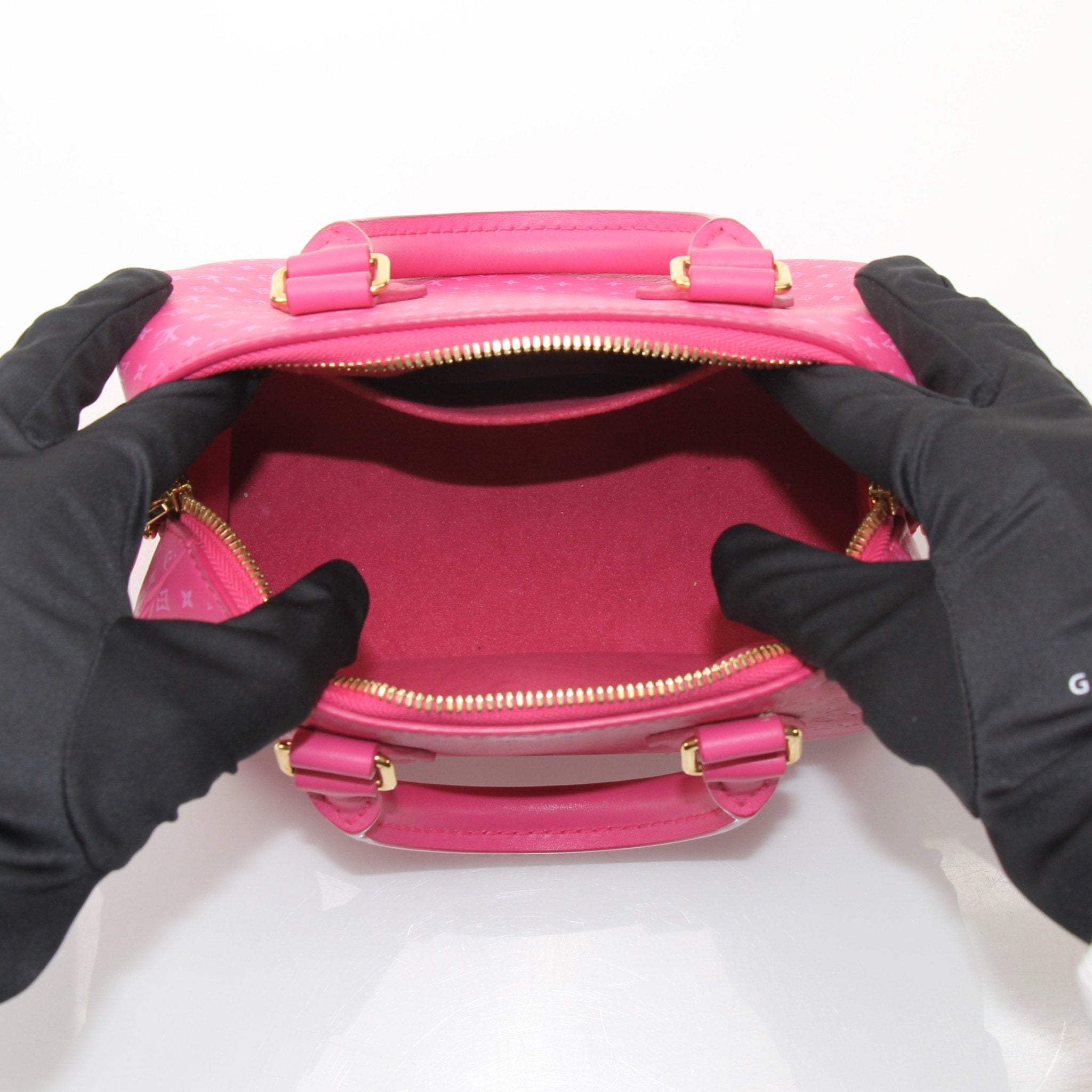 Pink Louis Vuitton Speedy 20 handbag with gold-tone hardware and a top handle, featuring a compact, stylish design.