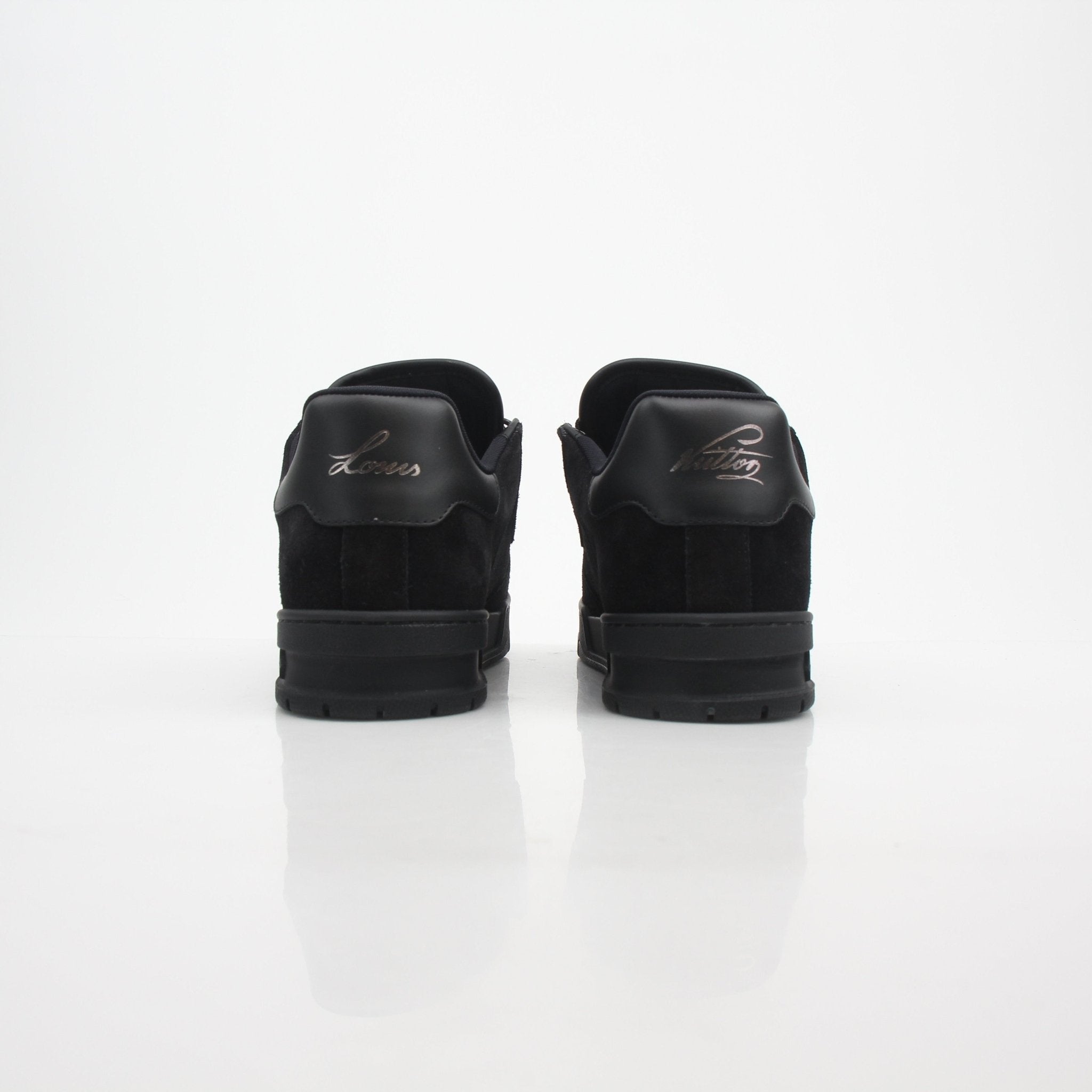 Louis Vuitton Men's LV Trainer black suede sneakers on a white background, showcasing stylish and comfortable shoes.