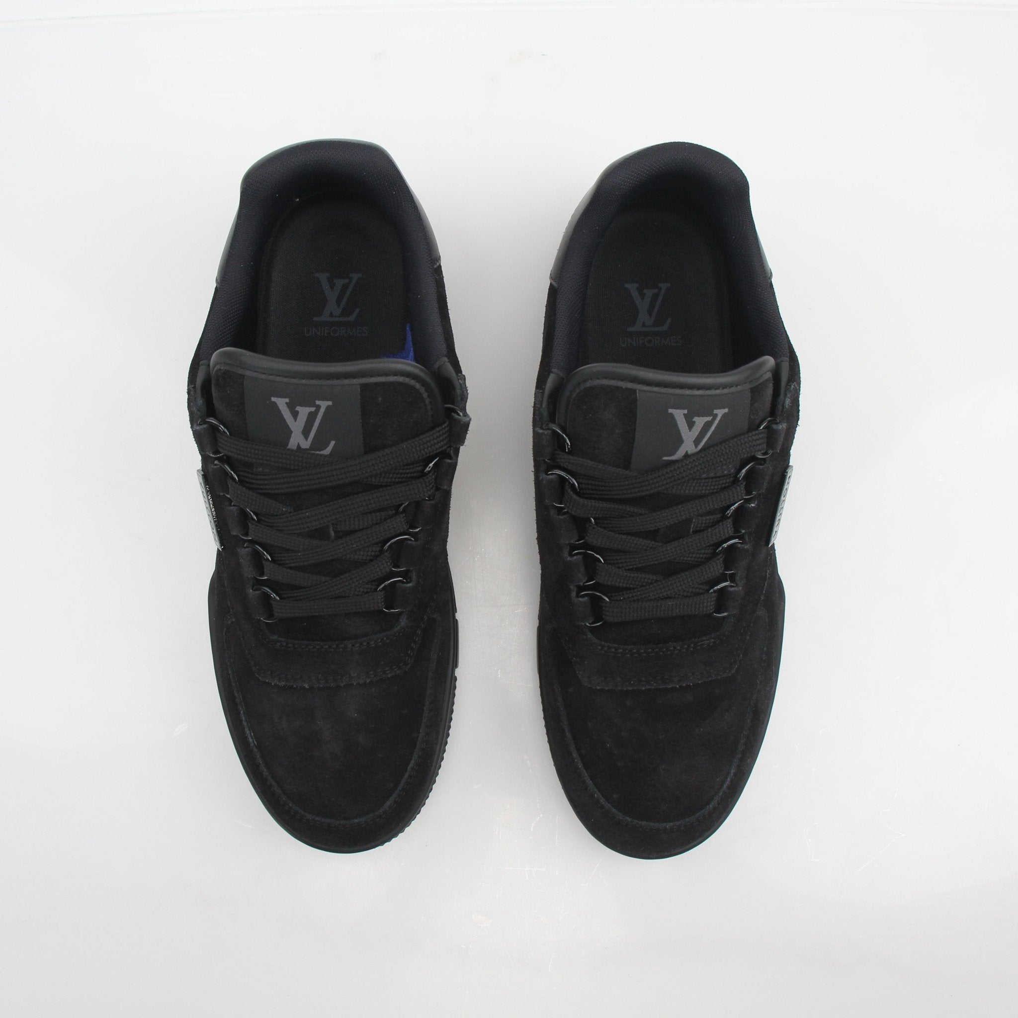 Louis Vuitton Men’s LV Trainer black suede sneakers with gold accents, showing the stylish design and textured material.