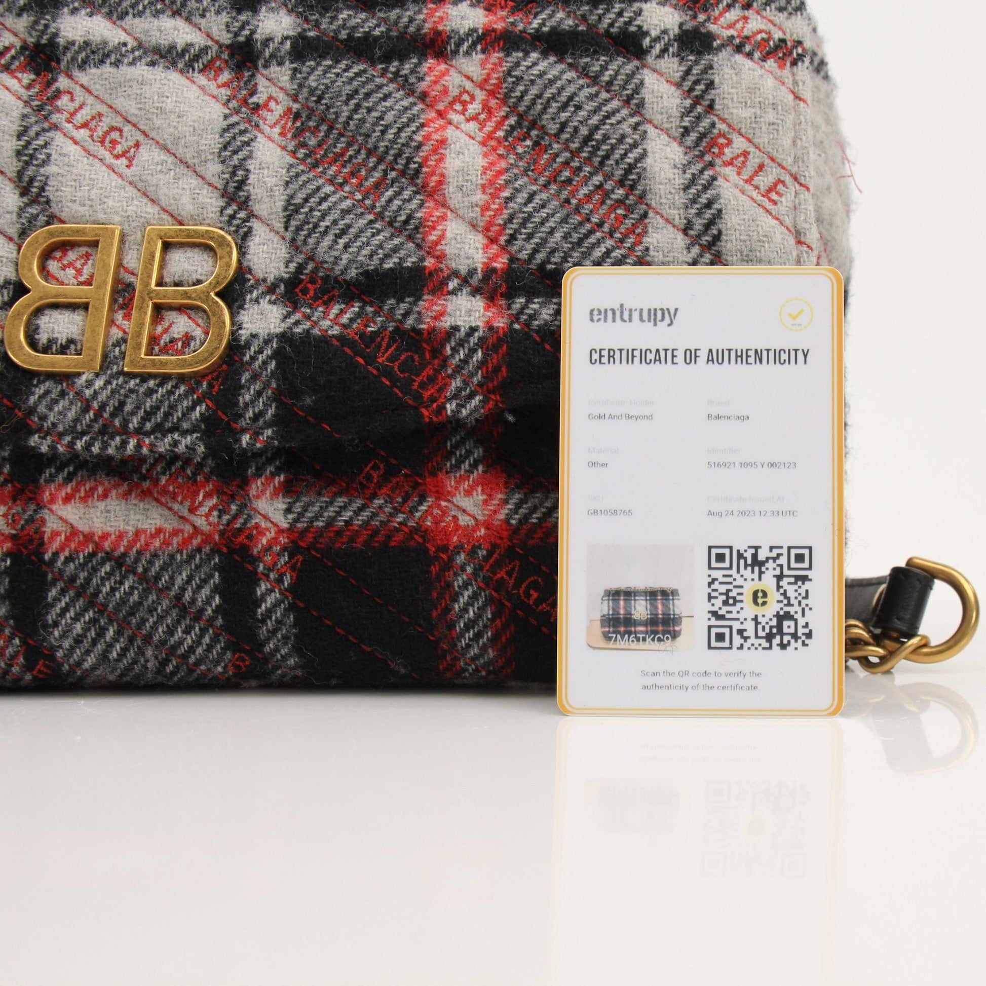 Gold & Beyond Balenciaga BB Chain Bag handbag with gold chain strap and signature logo design on black leather.