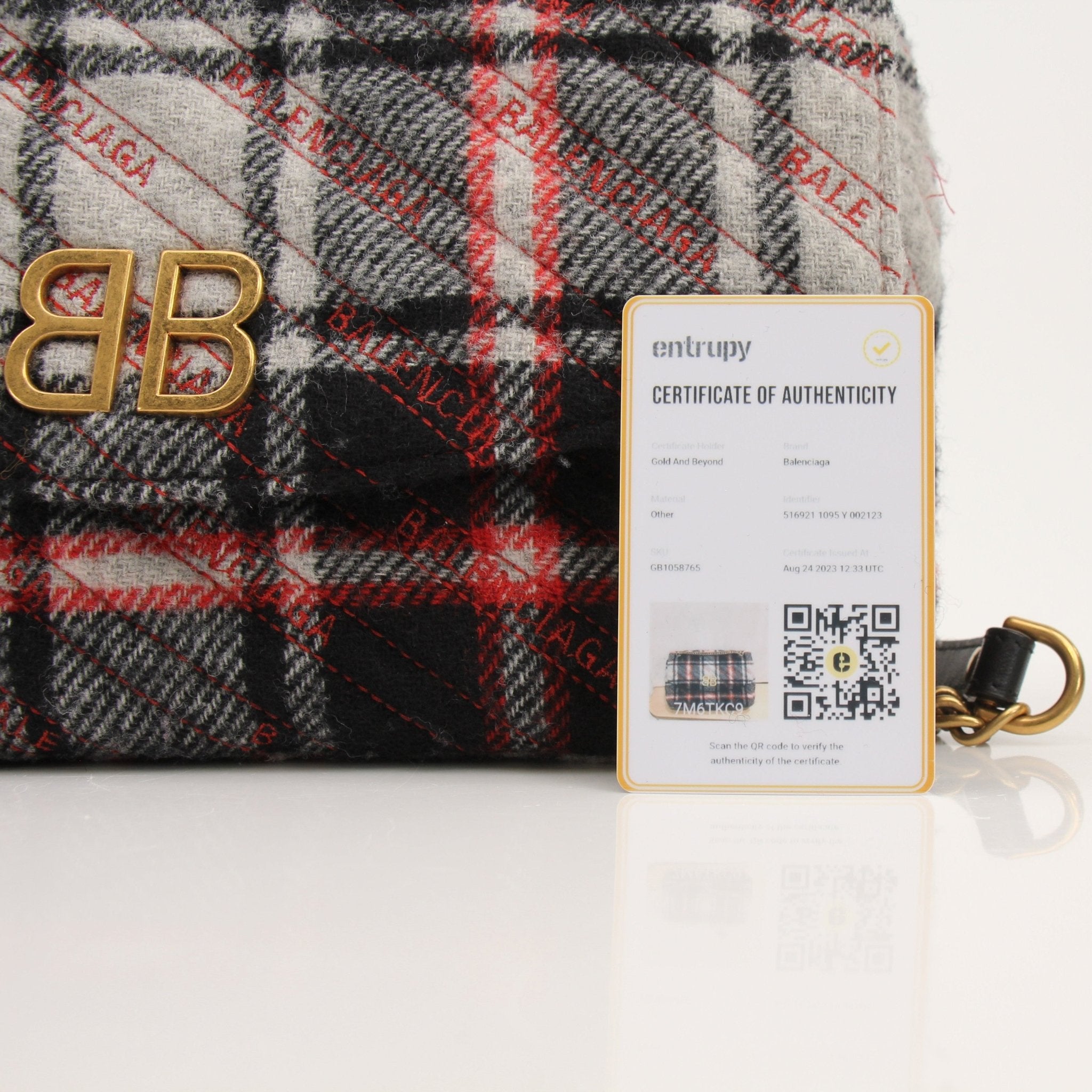 Gold & Beyond Balenciaga BB Chain Bag handbag with gold chain strap and signature logo design on black leather.