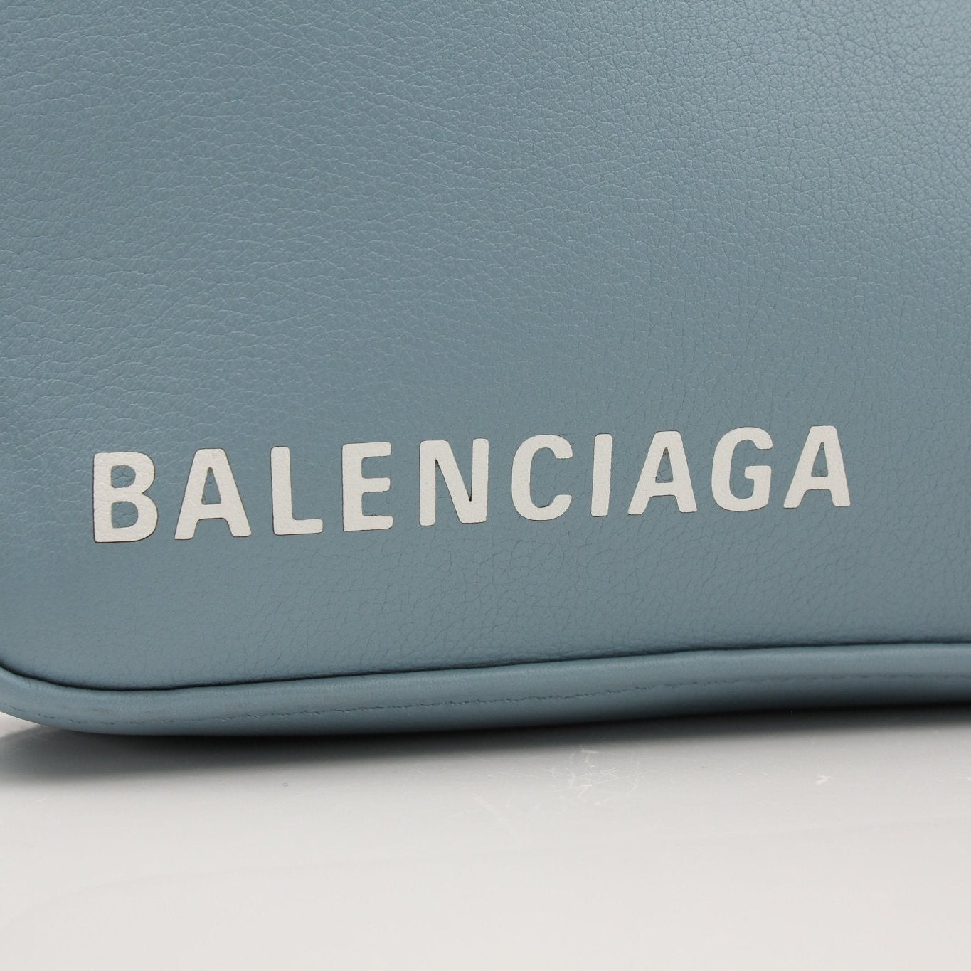 Gold &amp; Beyond Balenciaga Triangle Pouch handbag with sleek design and signature geometric logo on a neutral background.