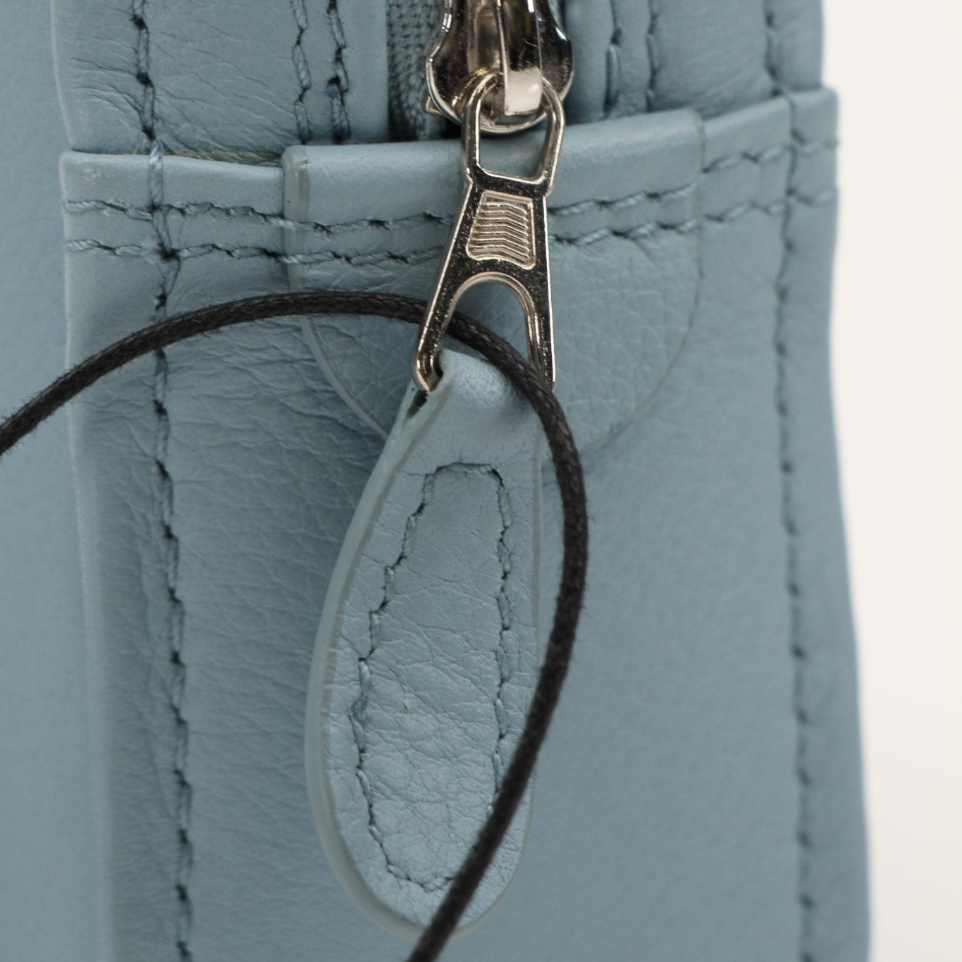 Gold & Beyond Balenciaga Triangle Pouch handbag featuring a sleek design and distinctive triangle logo on the front.