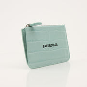 Gold & Beyond Balenciaga card holder wallet with sleek design and multiple card slots, displayed on a neutral background.