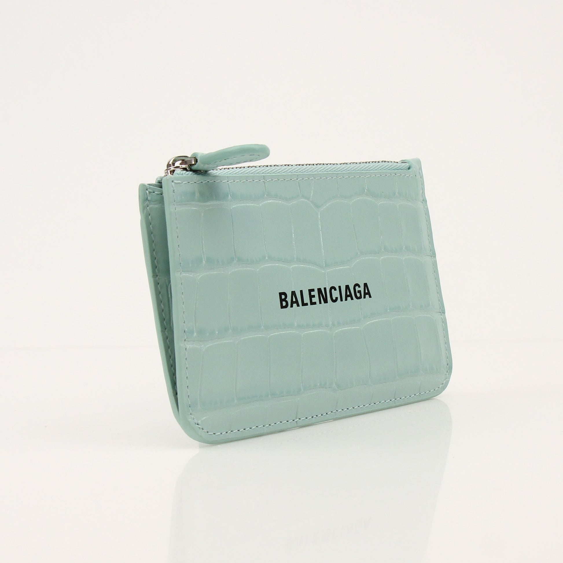 Gold & Beyond Balenciaga card holder wallet with sleek design and multiple card slots, displayed on a neutral background.