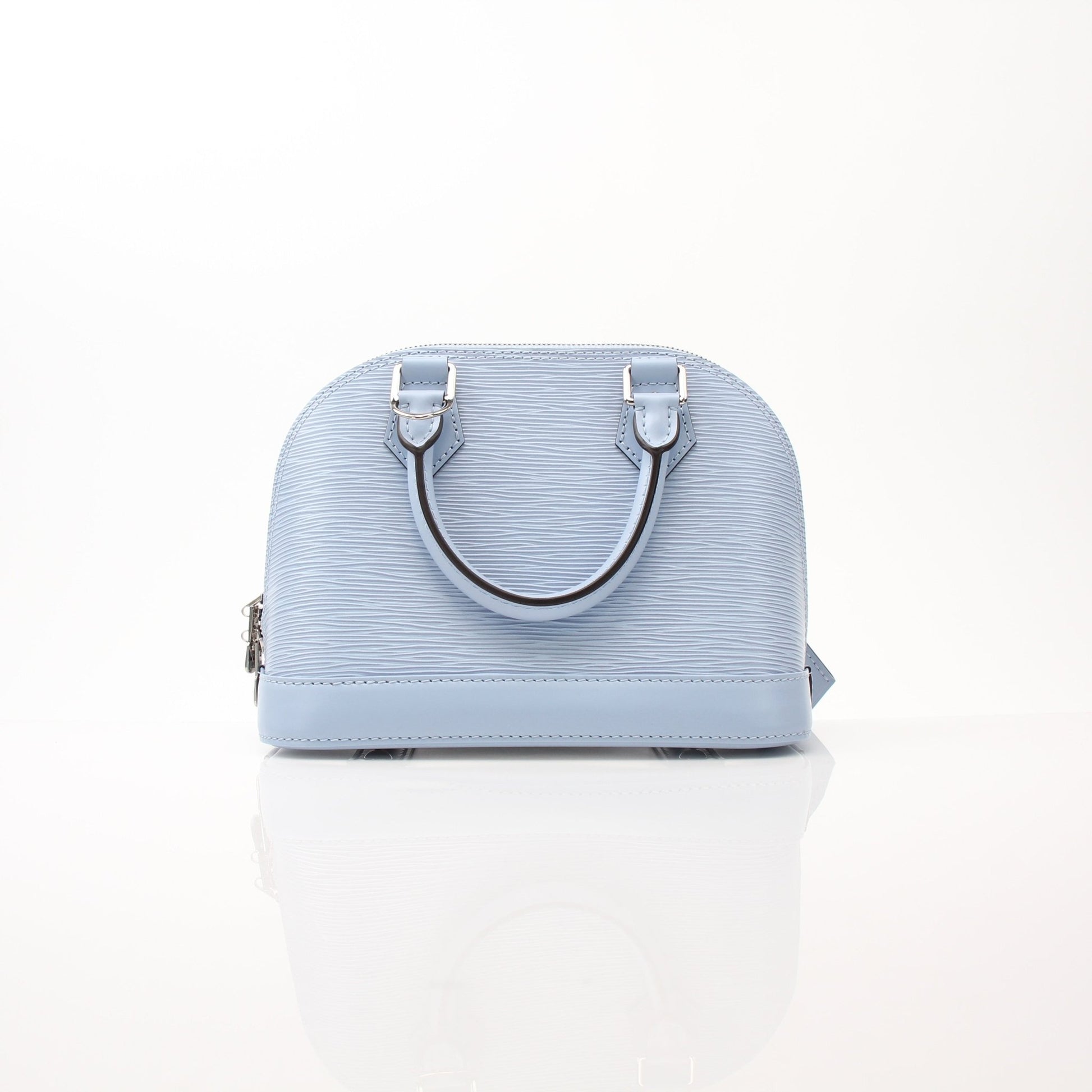 Louis Vuitton Blue Nuage Alma BB handbag with gold hardware, featuring structured shape and top handles in a luxurious design.