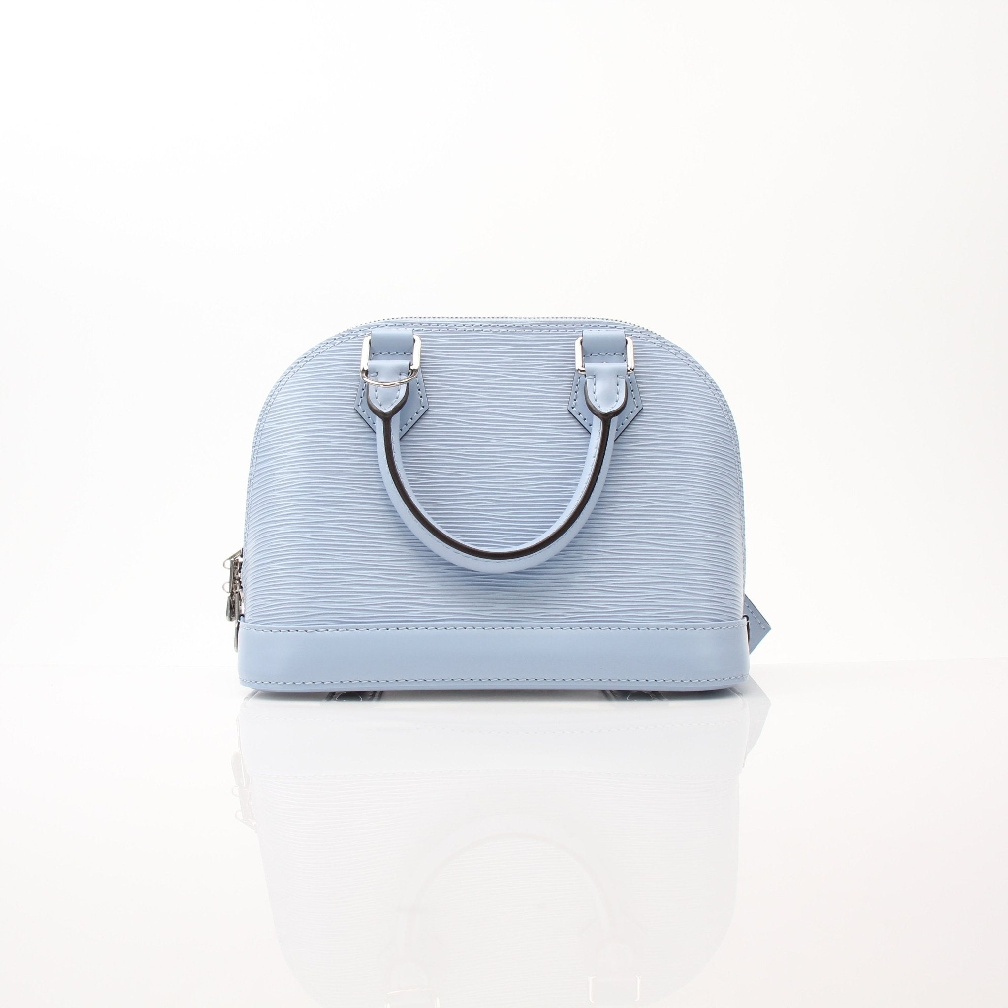 Louis Vuitton Blue Nuage Alma BB handbag with gold hardware, featuring structured shape and top handles in a luxurious design.