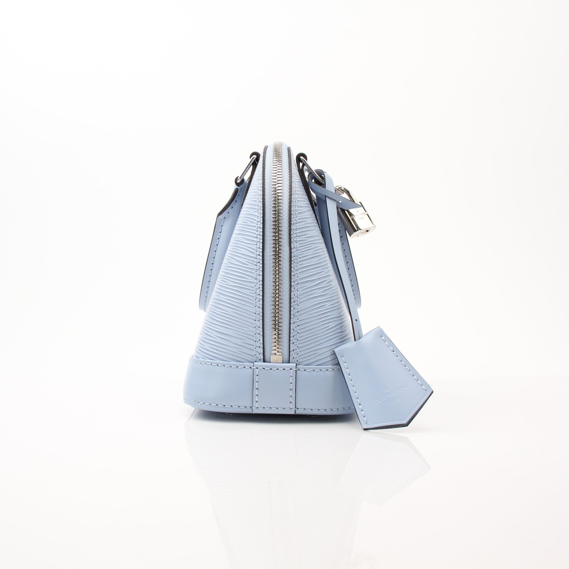 Louis Vuitton Blue Nuage Alma BB handbag with gold hardware, structured leather design, and top handle on a white background.