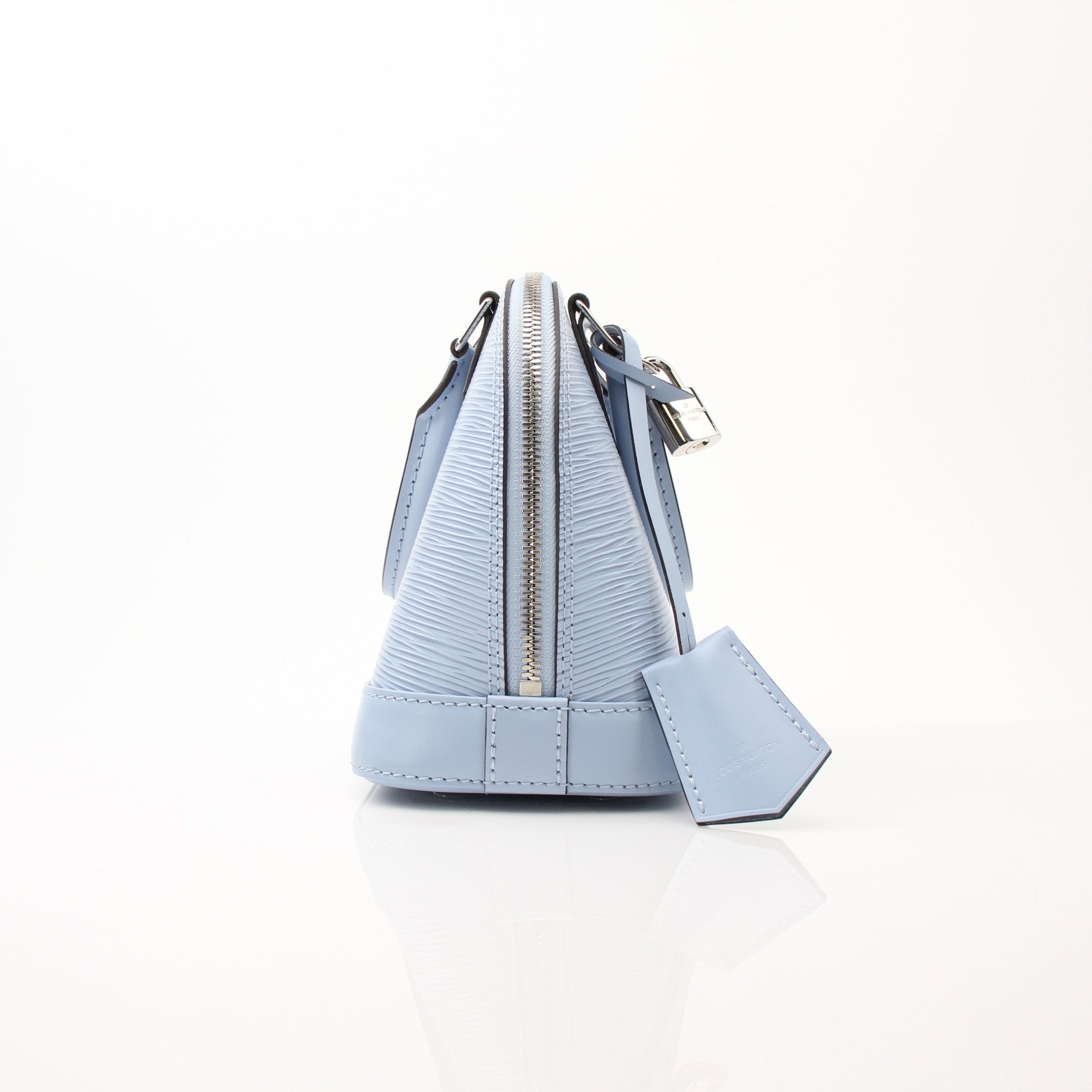 Louis Vuitton Blue Nuage Alma BB handbag with gold hardware, structured leather design, and top handle on a white background.
