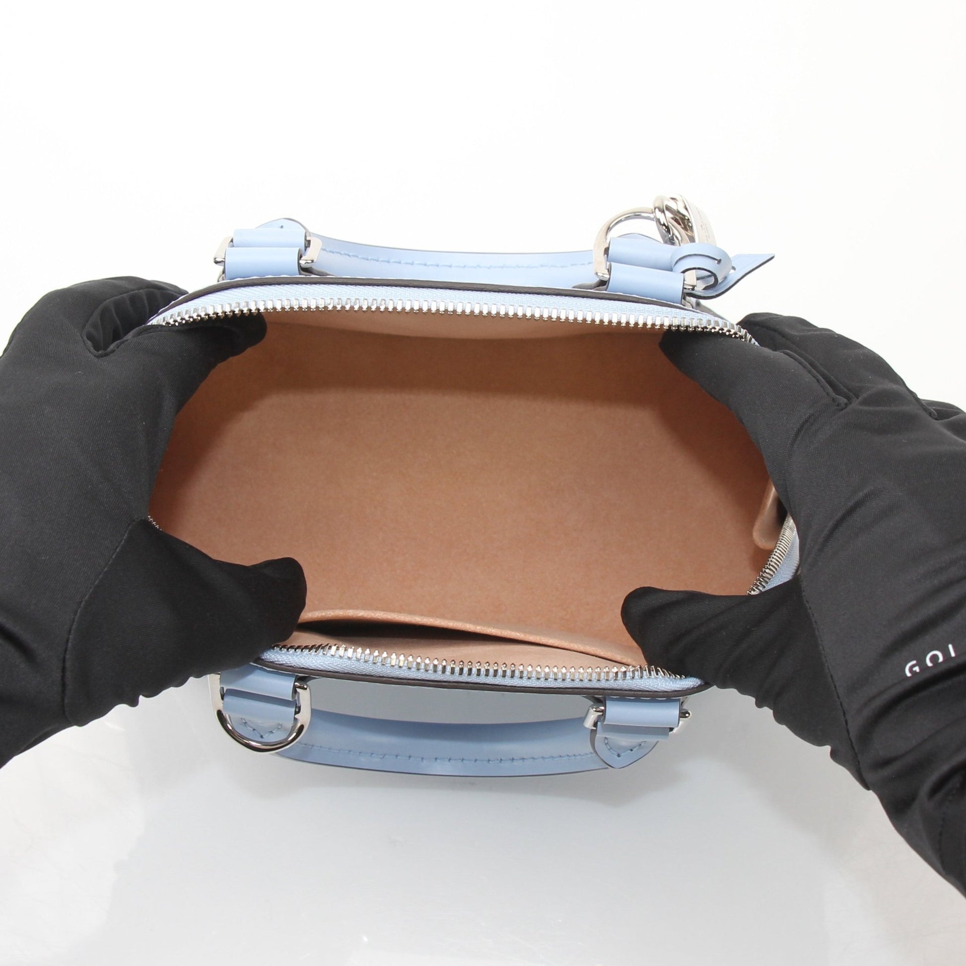 Blue Louis Vuitton Nuage Alma BB handbag with gold accents, featuring a structured design and top handles.