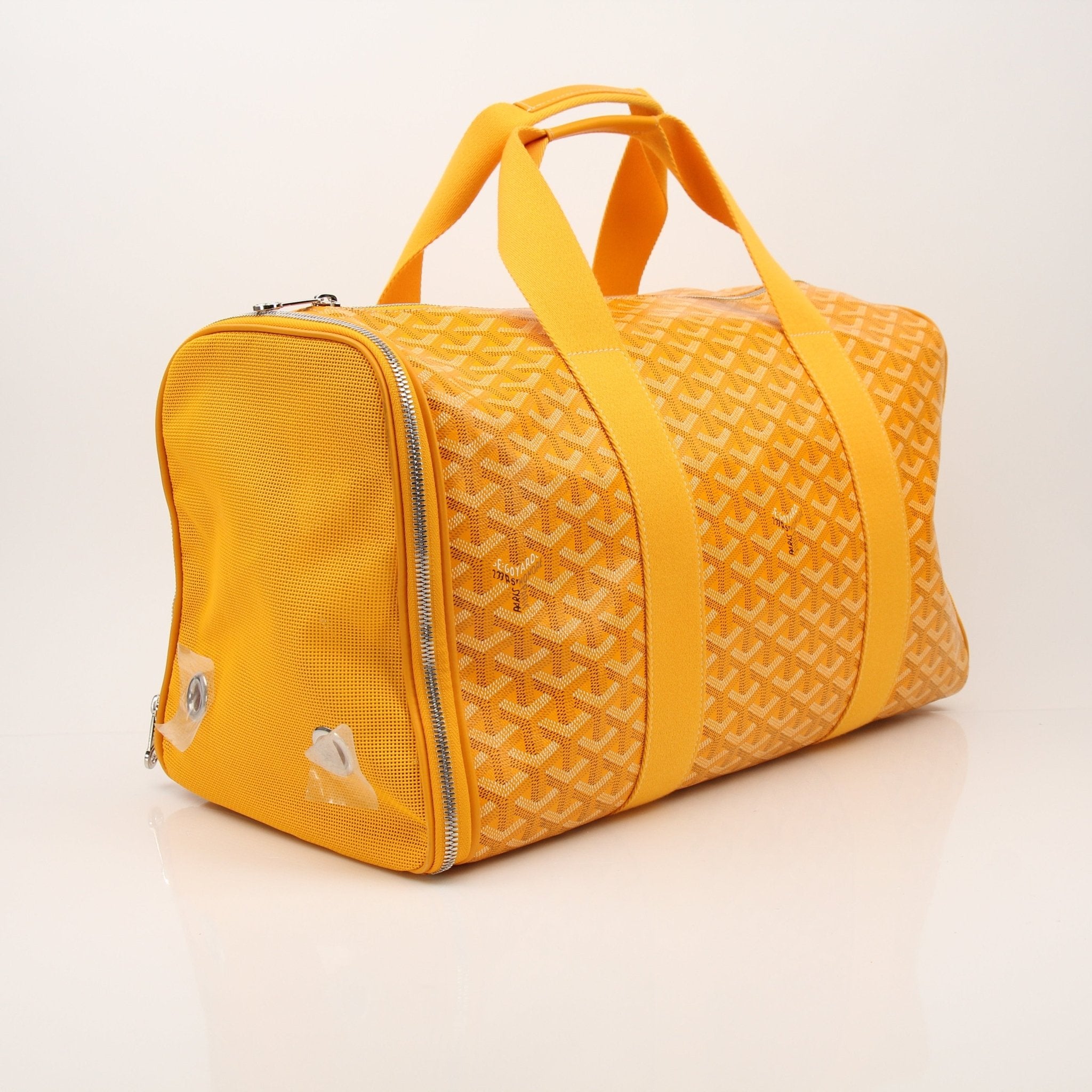 Gold & Beyond Goyard Voltiguer dog carrier travel bag with top handle and side pocket for pet transportation.