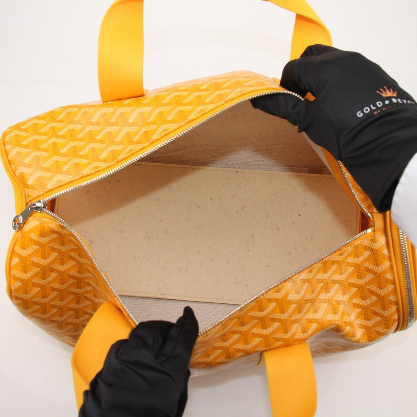 Gold & Beyond Goyard Voltiguer dog carrier travel bag with leather handles and patterned fabric for pet transport.