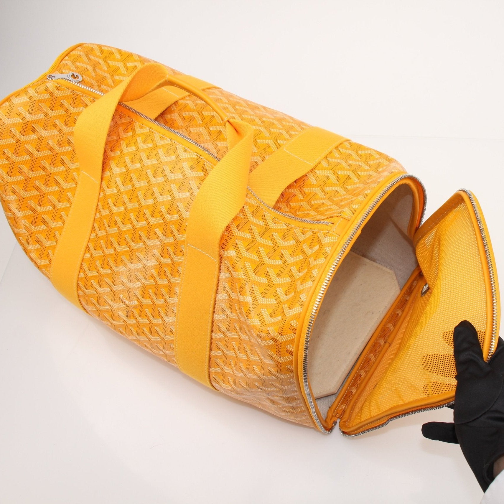 Gold & Beyond Goyard Voltiguer dog carrier travel bag with top handle and zip closure, featuring Goyard pattern and padded interior.