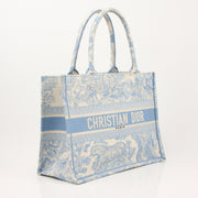 Christian Dior Book Tote handbag with gold accents, featuring the signature Dior design and spacious interior.