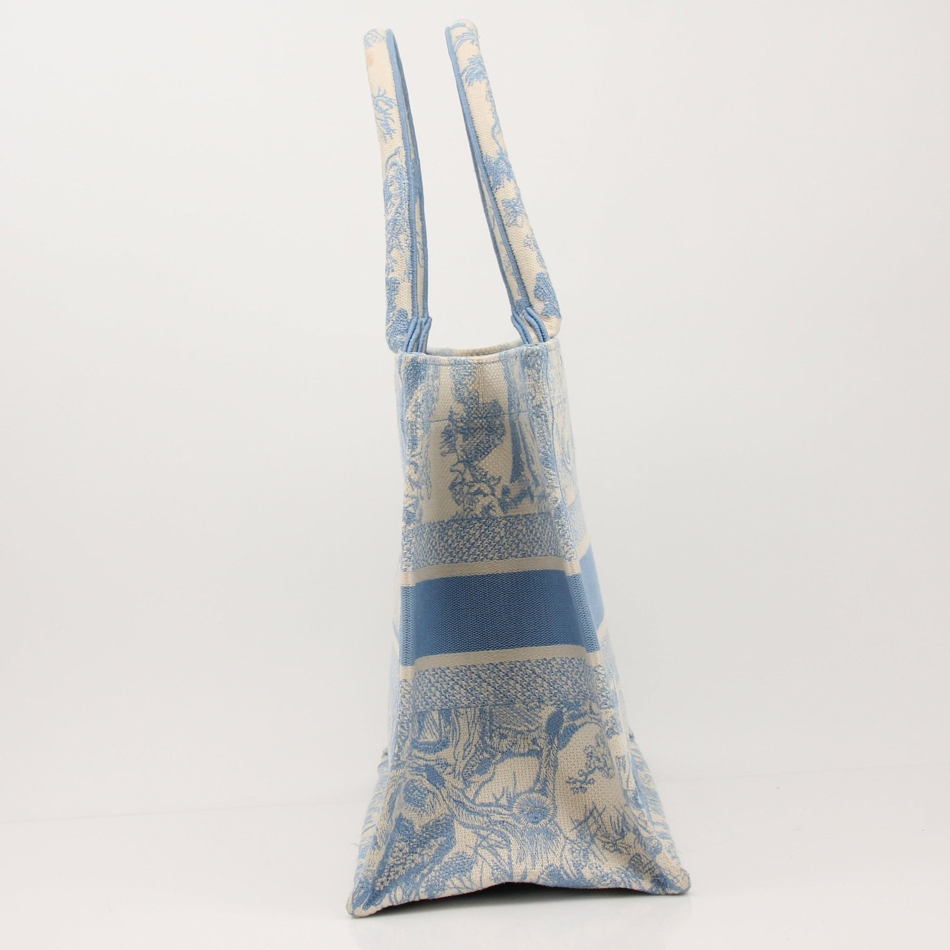 Christian Dior Book Tote handbag with gold accents, featuring a stylish design and spacious interior, crafted by Gold & Beyond.