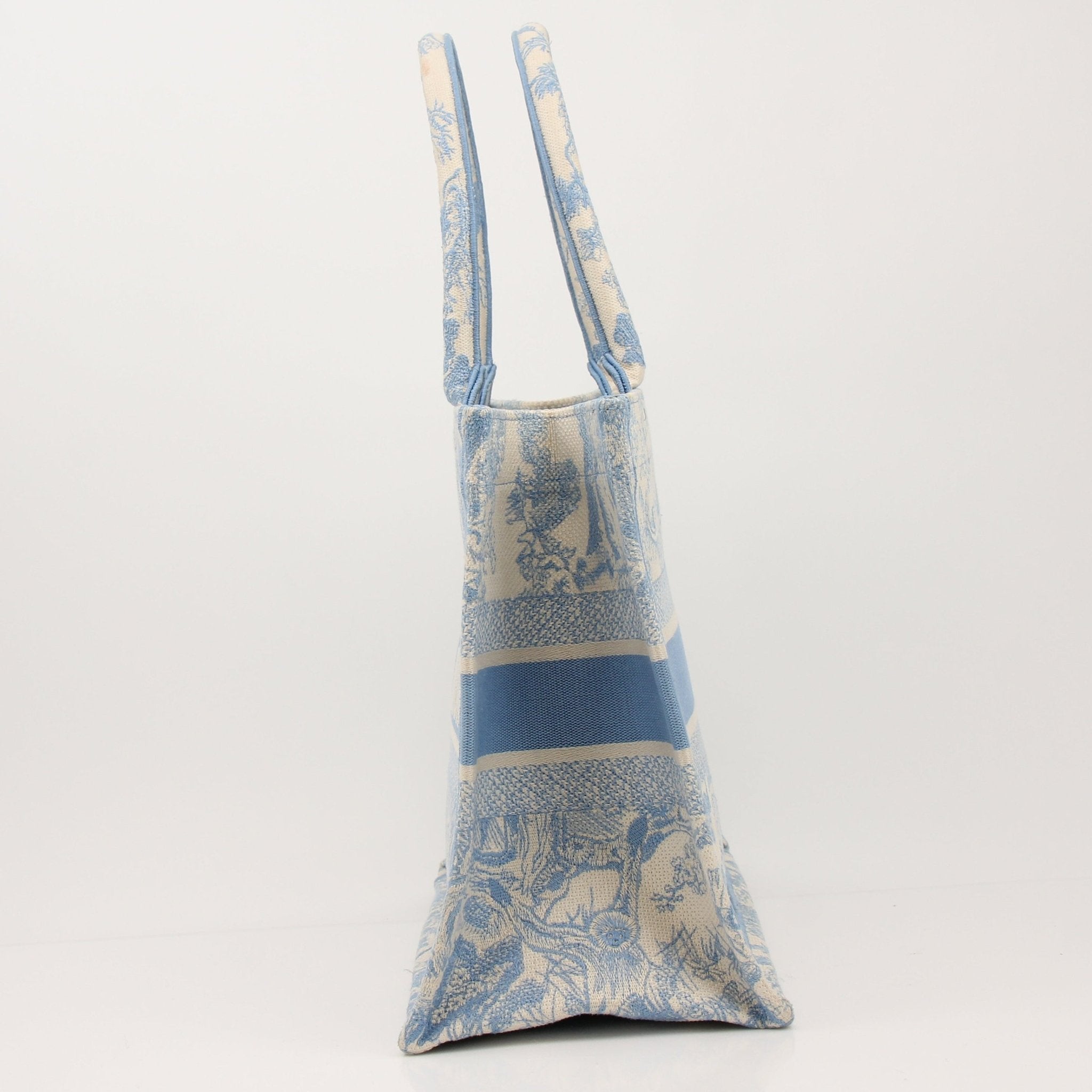 Christian Dior Book Tote handbag with gold accents, featuring a stylish design and spacious interior, crafted by Gold & Beyond.