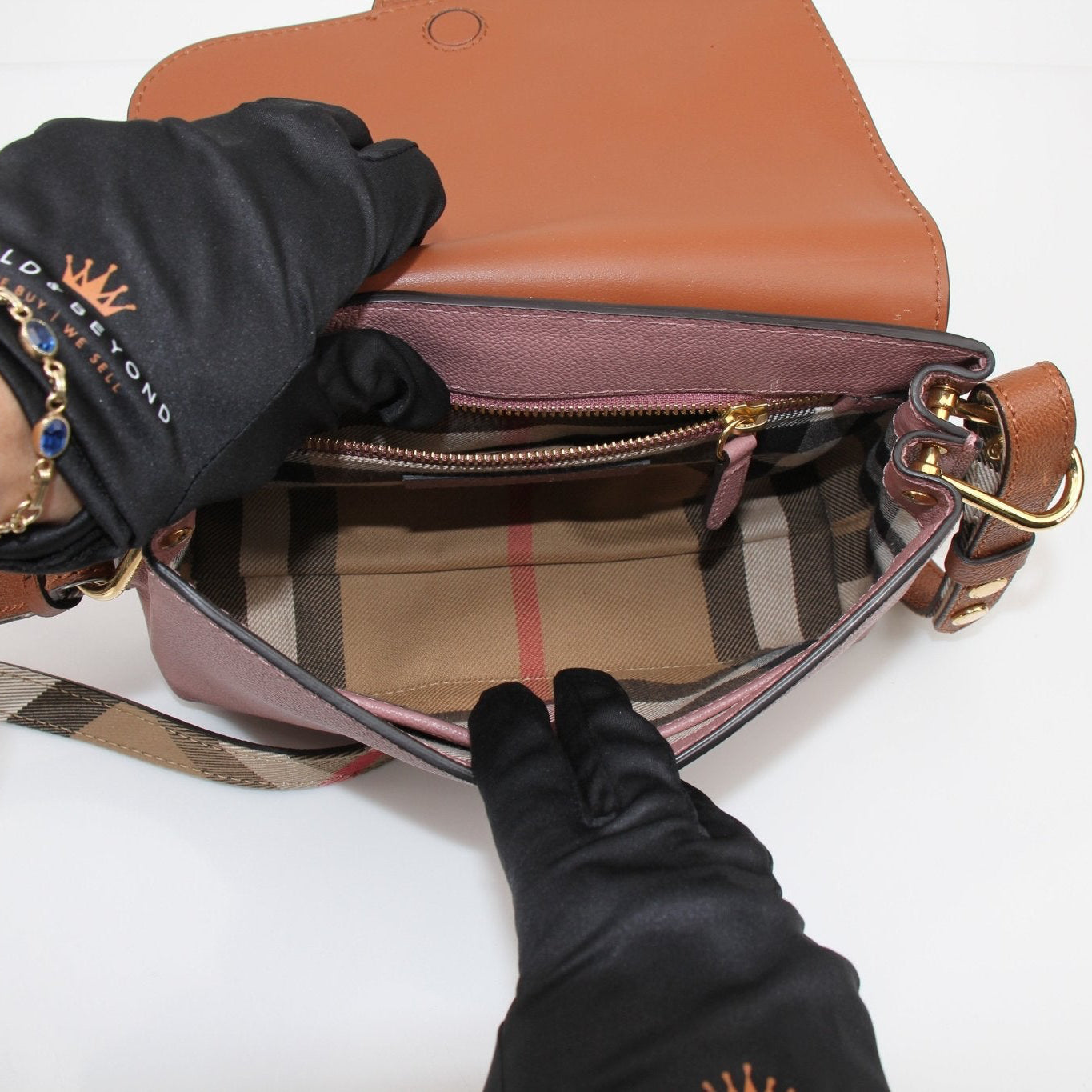 Gold &amp; Beyond Burberry buckle crossbody handbag with adjustable strap and classic check pattern, stylish and functional accessory.