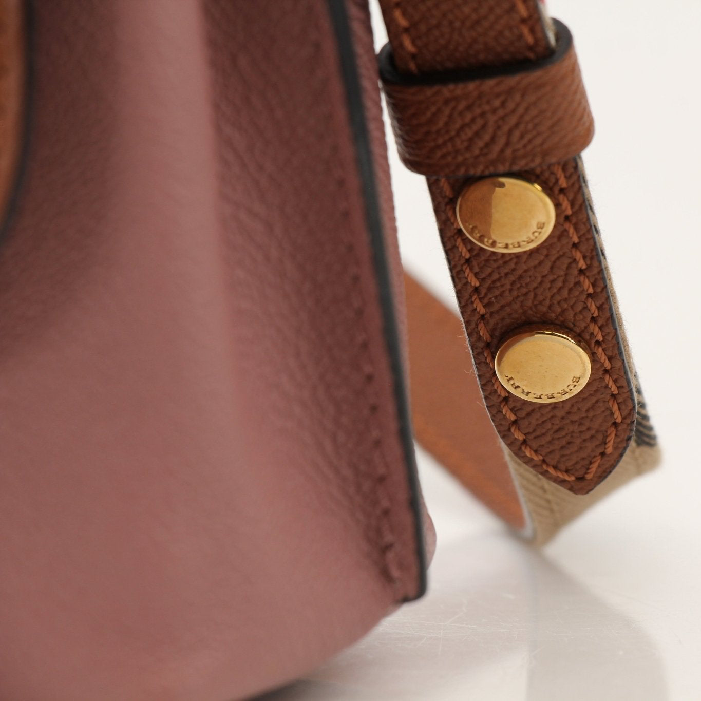 Gold & Beyond Burberry buckle crossbody handbag featuring a sleek design and adjustable strap.