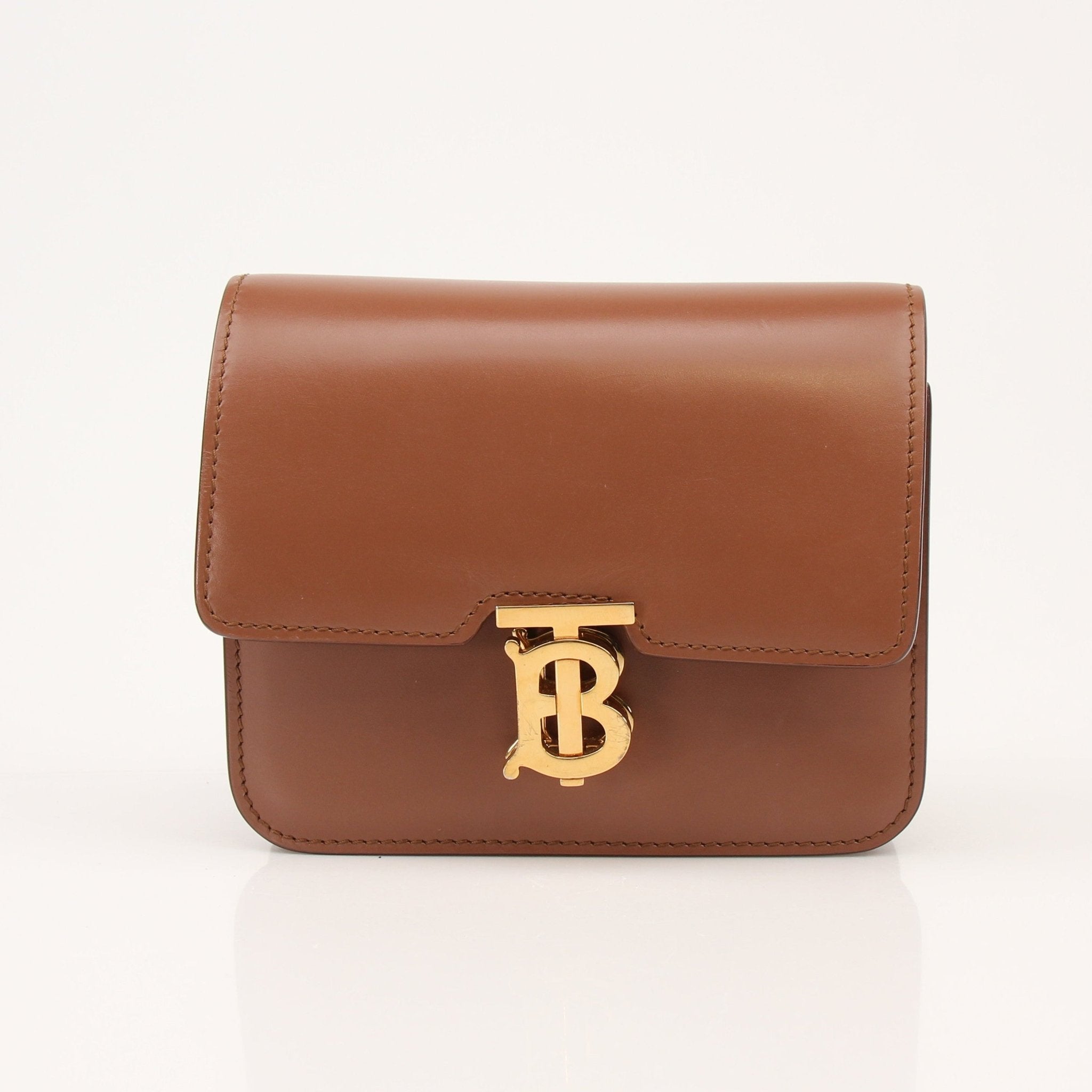 Gold & Beyond Burberry TB Bag handbag featuring a stylish design with a gold-tone buckle and classic check pattern.