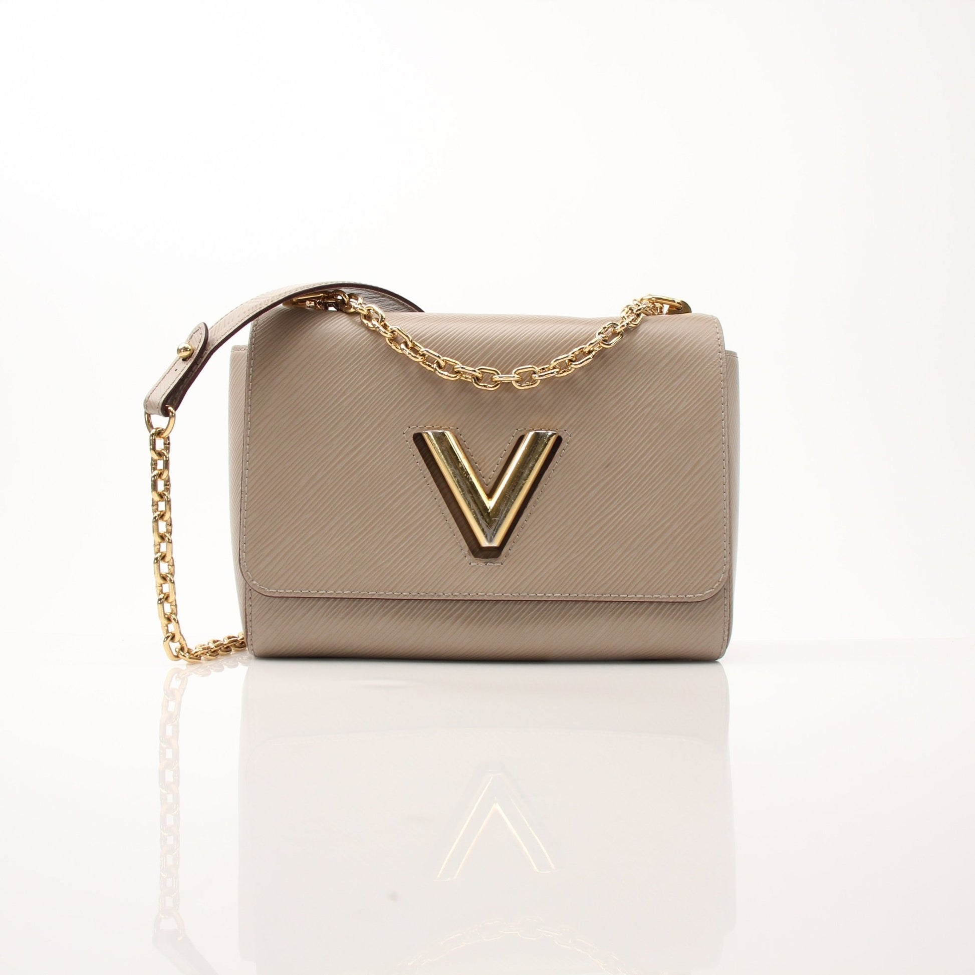 Louis Vuitton Beige Twist MM shoulder handbag with gold hardware and structured design, featuring the signature monogram pattern.
