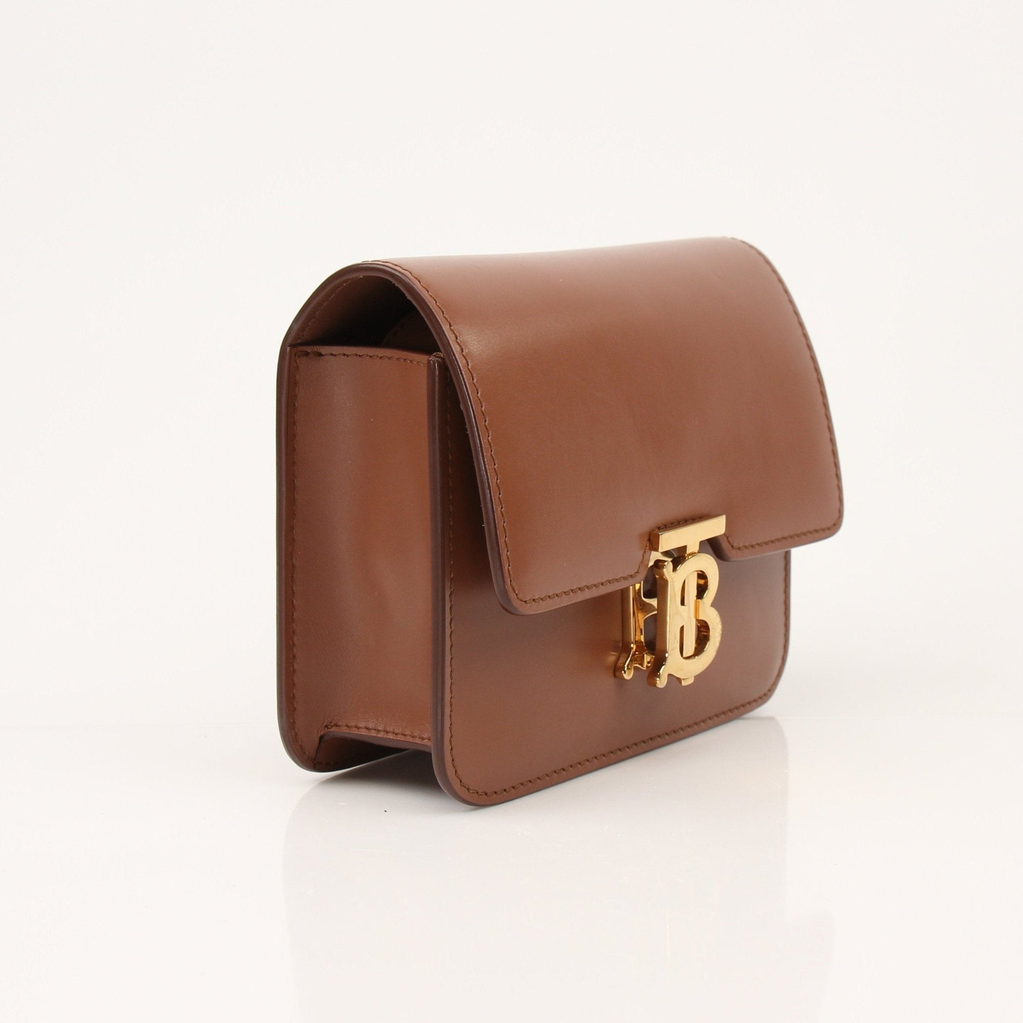 Gold & Beyond Burberry TB Bag handbag with adjustable strap and iconic check pattern on textured leather.
