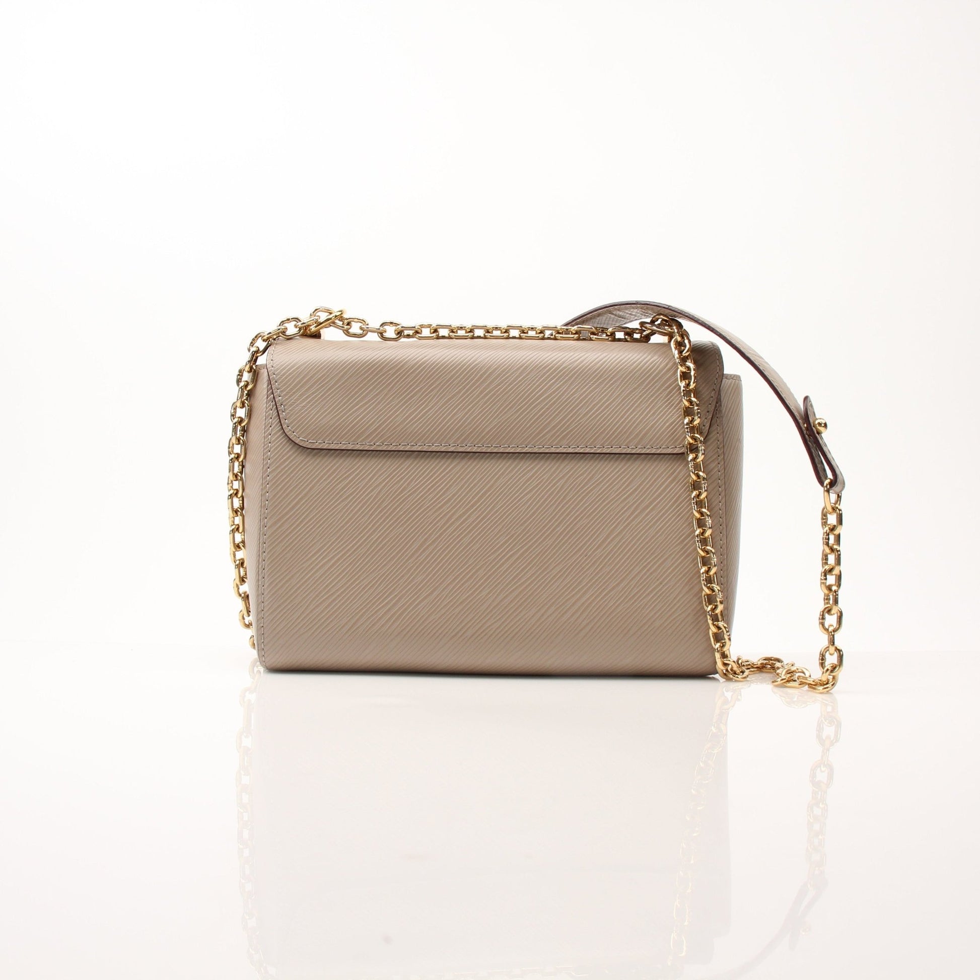 Beige Louis Vuitton Twist MM shoulder handbag with gold-tone hardware and structured design, displayed on a neutral background.